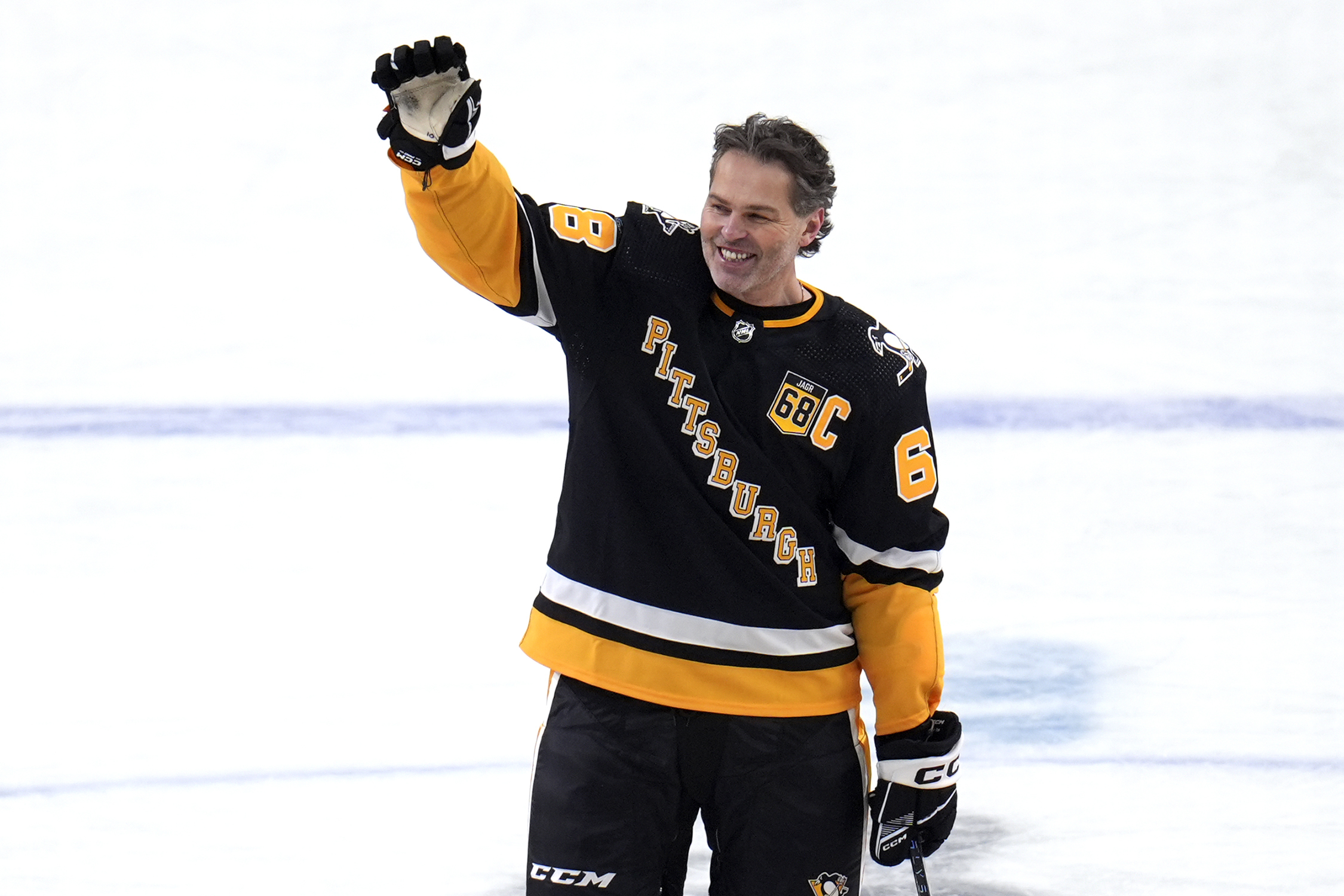 Former Pittsburgh Penguins player Jaromir Jagr stands at center ice...