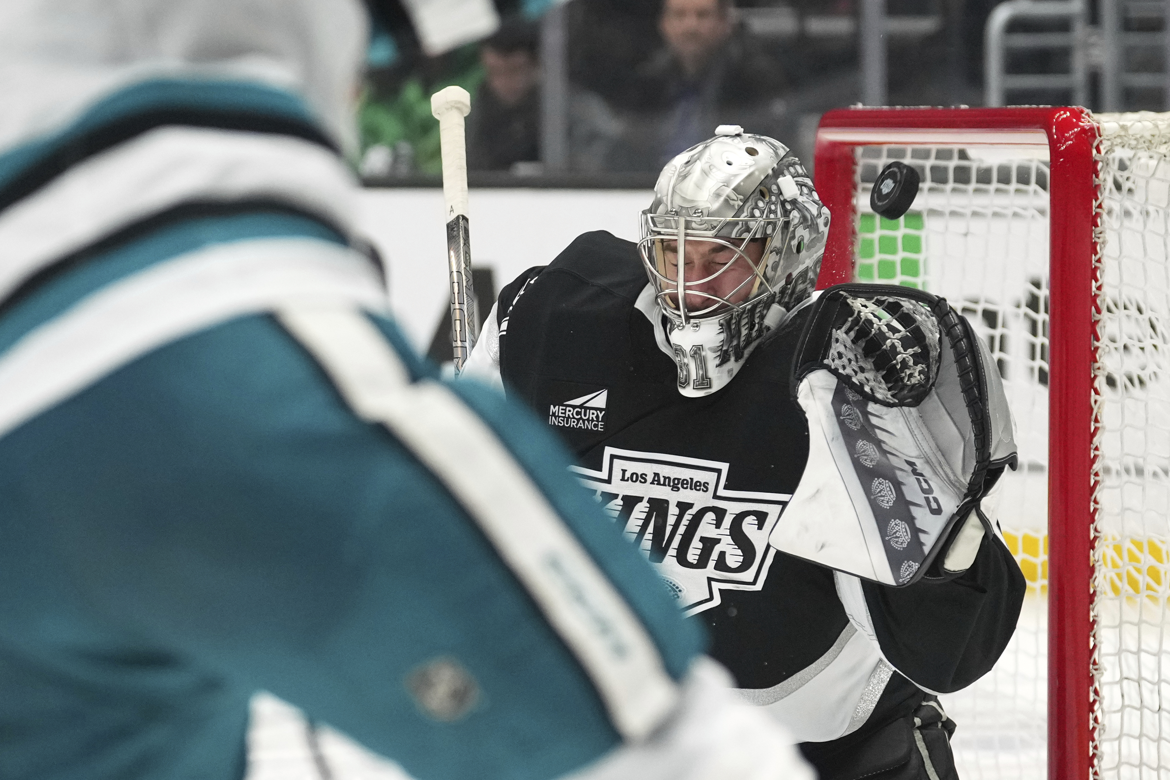 Kings goaltender David Rittich deflects a shot by San Jose...