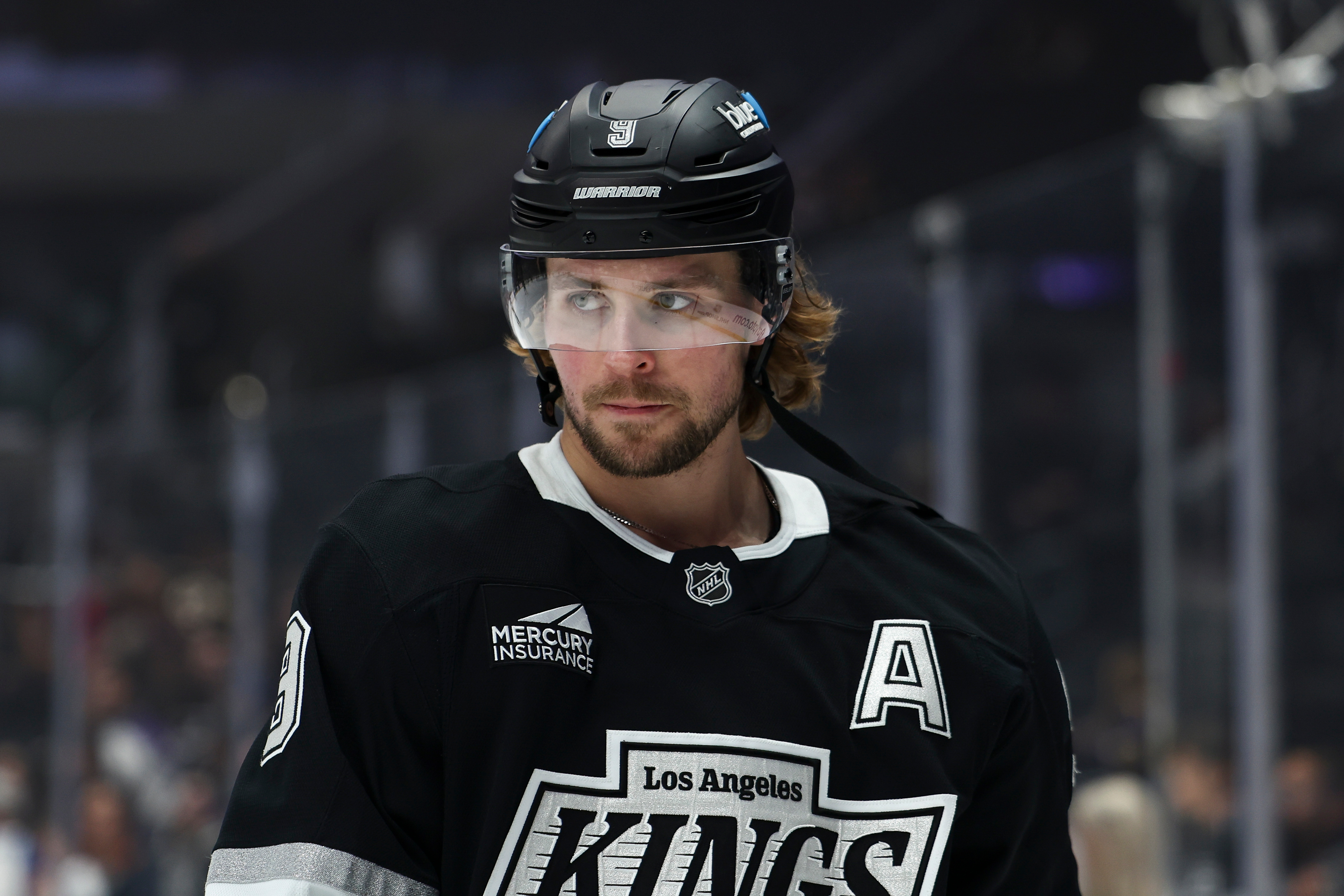 Kings right wing Adrian Kempe looks on before a game...