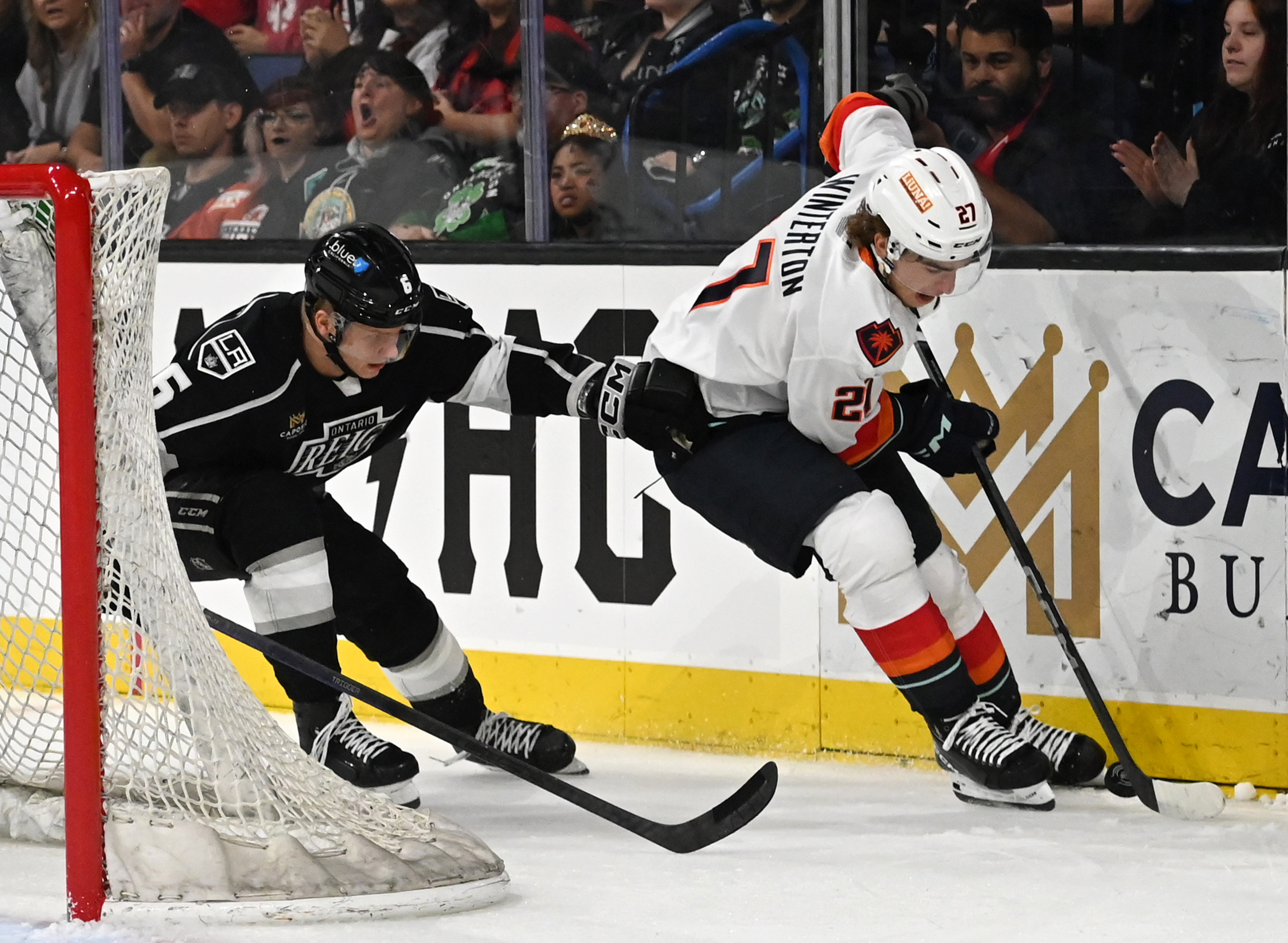 Coachella Valley Firebirds’ Ryan Winterton driblles guarded by Ontario Reign’s...