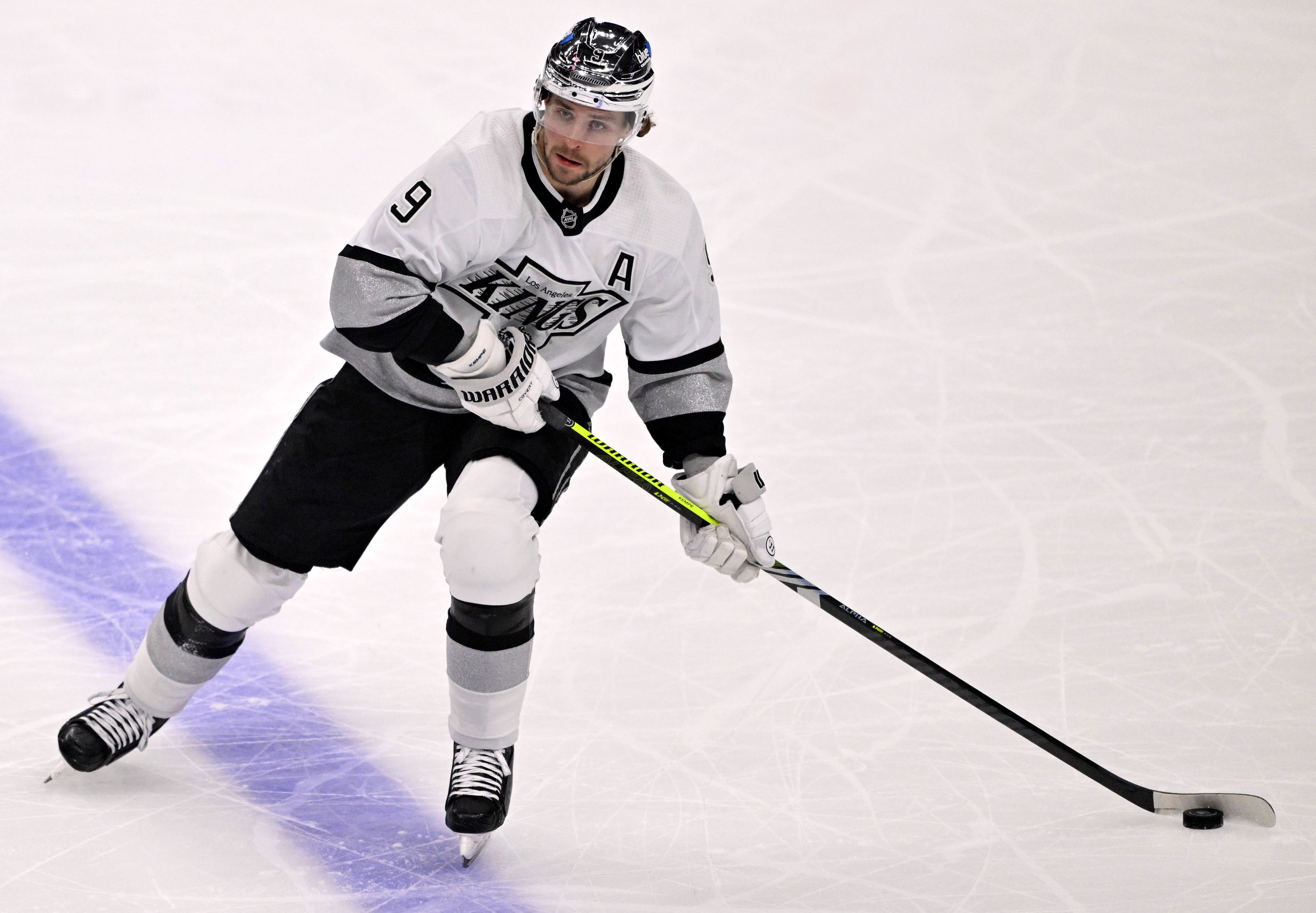 Adrian Kempe #9 of the Los Angeles Kings controls the...