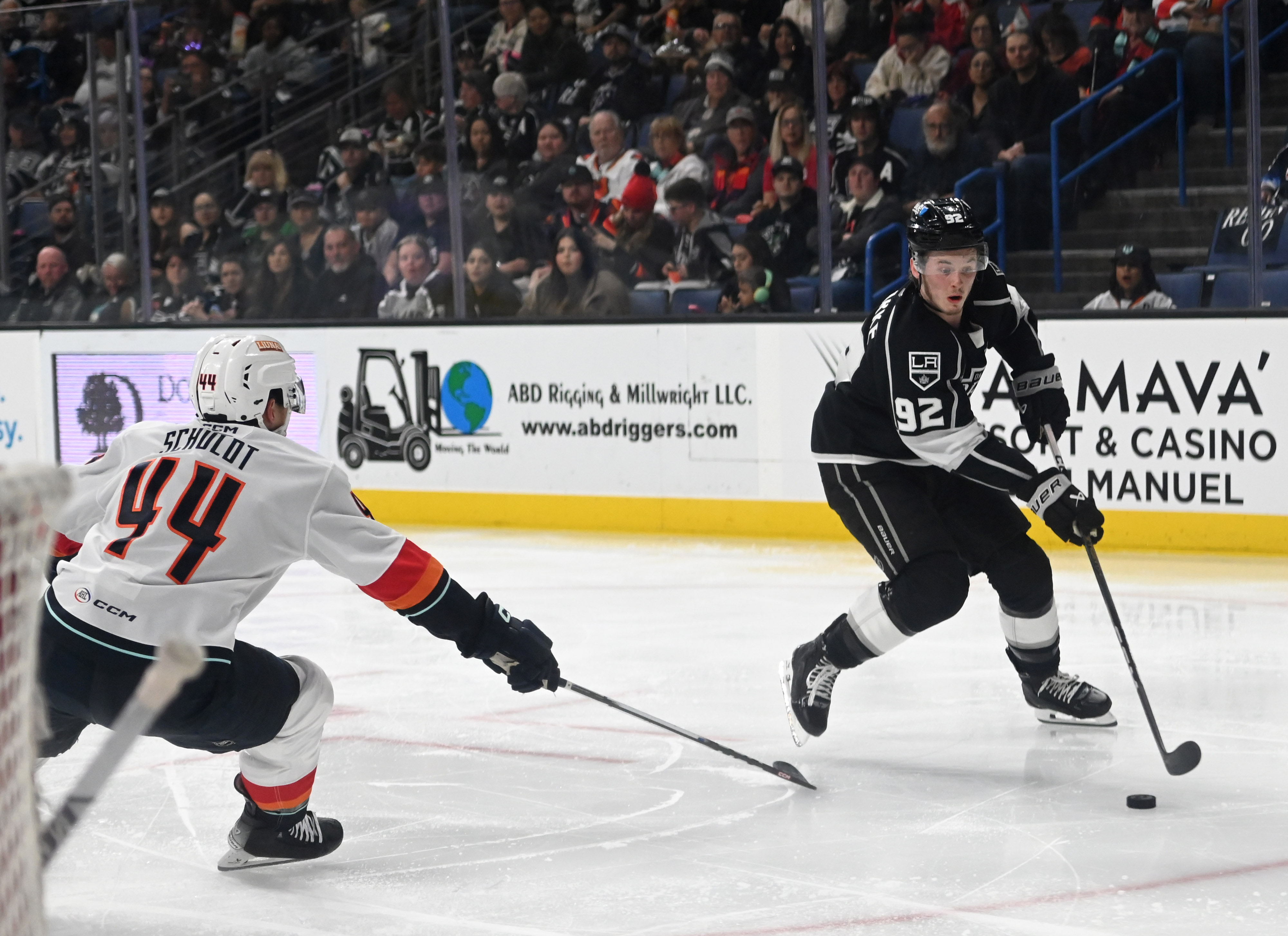 Ontario Reign’s Brandt Clarke dribbles the puck guarded by Coachella...