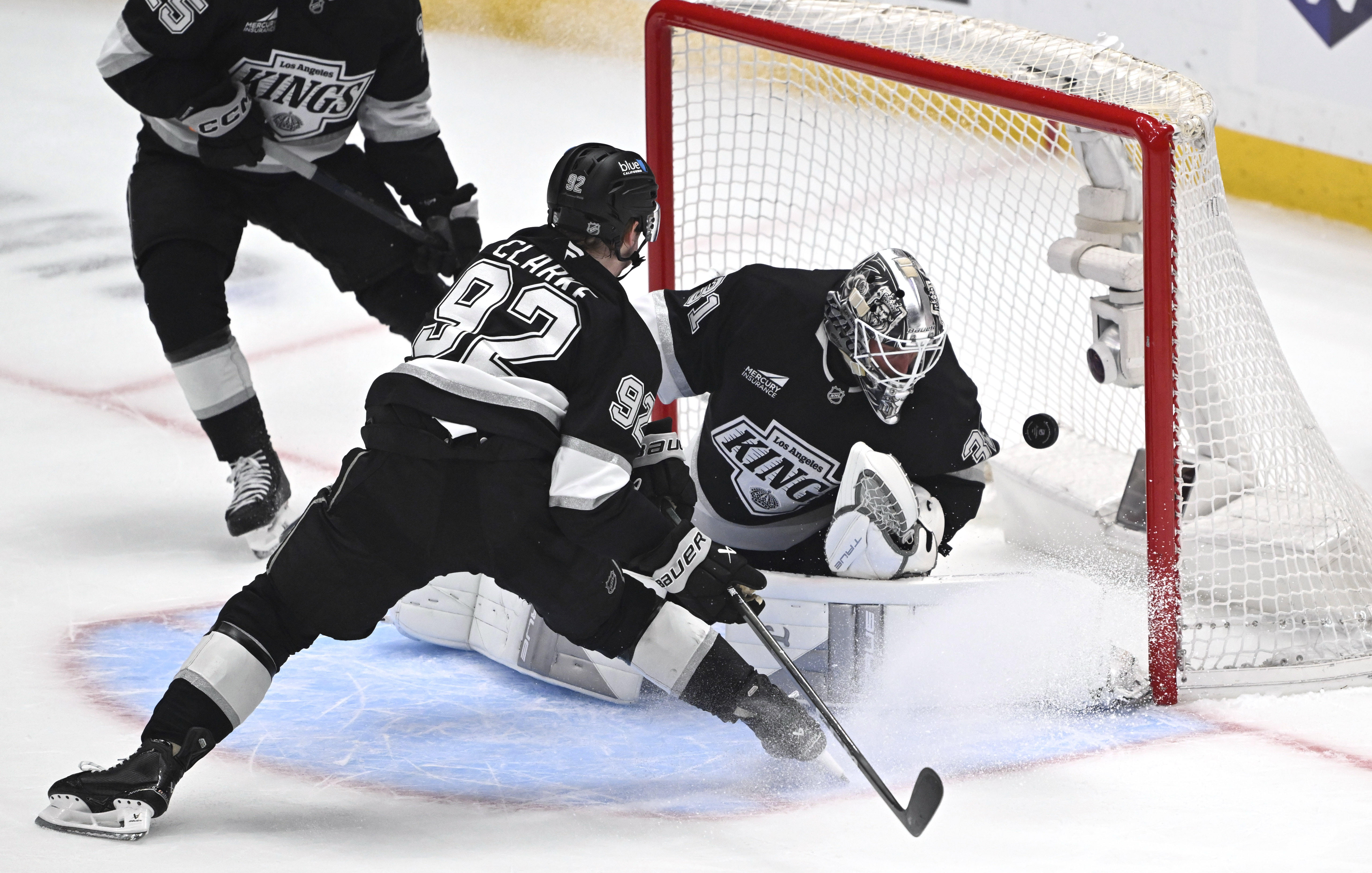 Kings goaltender Anton Forsberg, right, canât block a shot for...