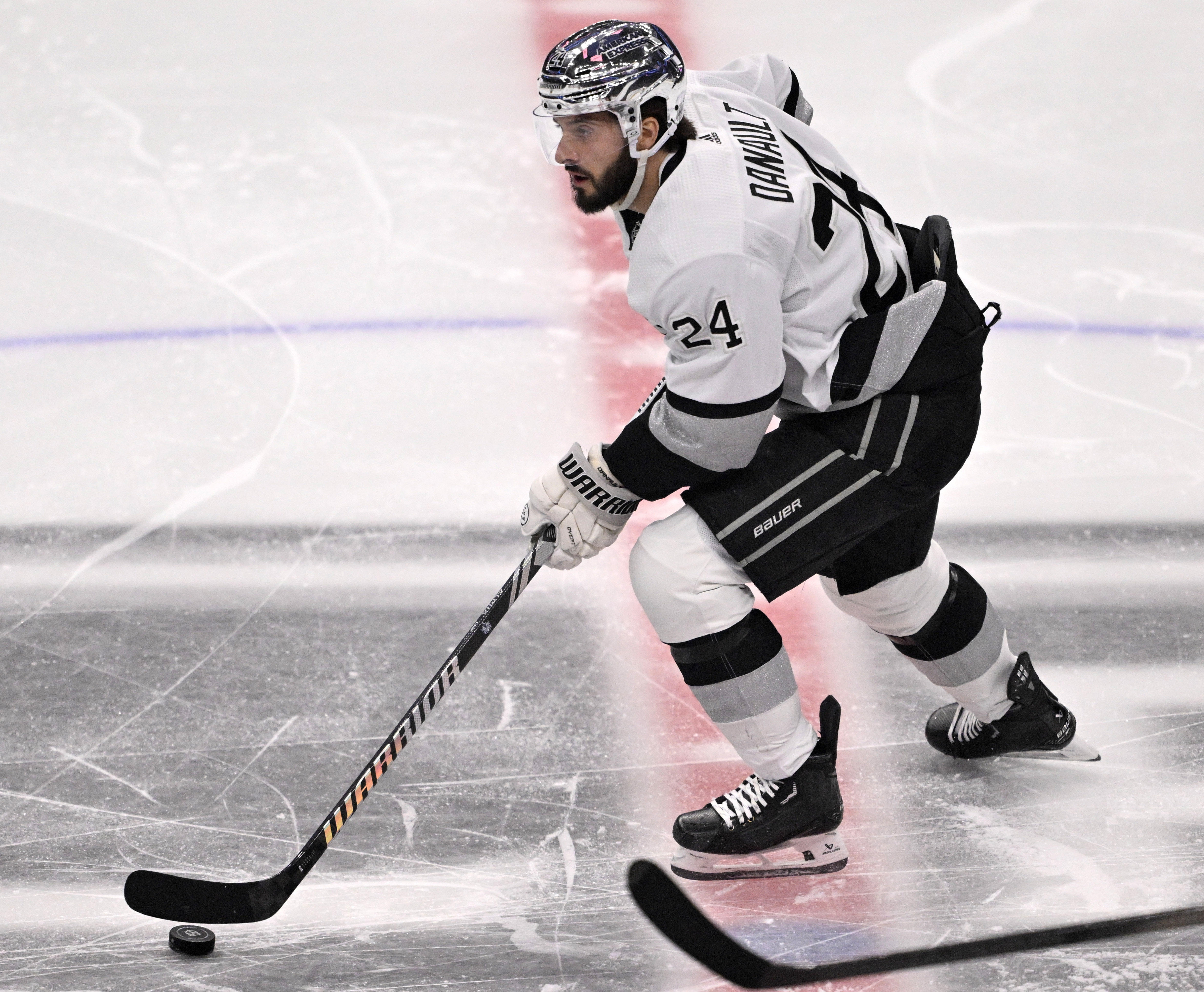 Phillip Danault #24 of the Los Angeles Kings controls the...