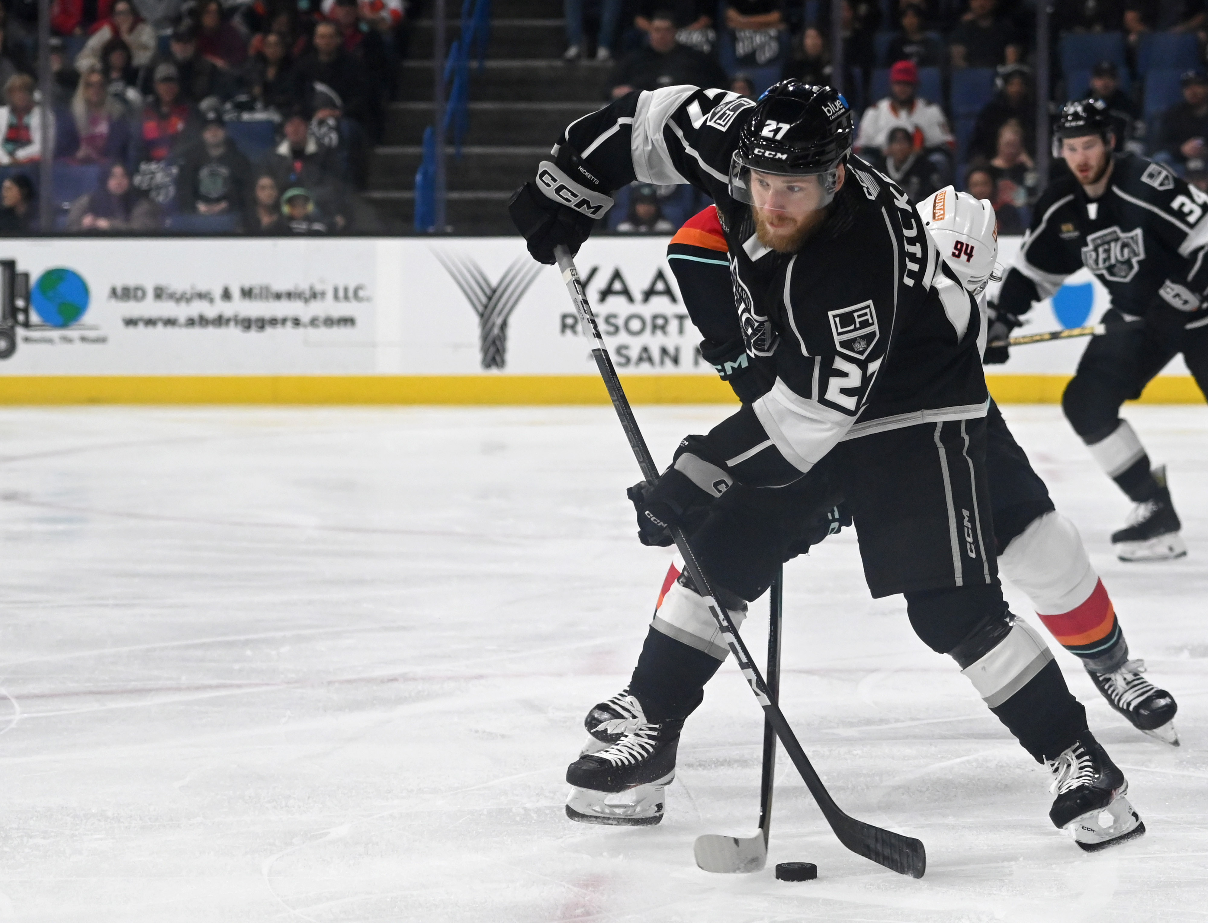 Ontario Reign’s Joe Hicketts dribbles the puck pressured by Coachella...