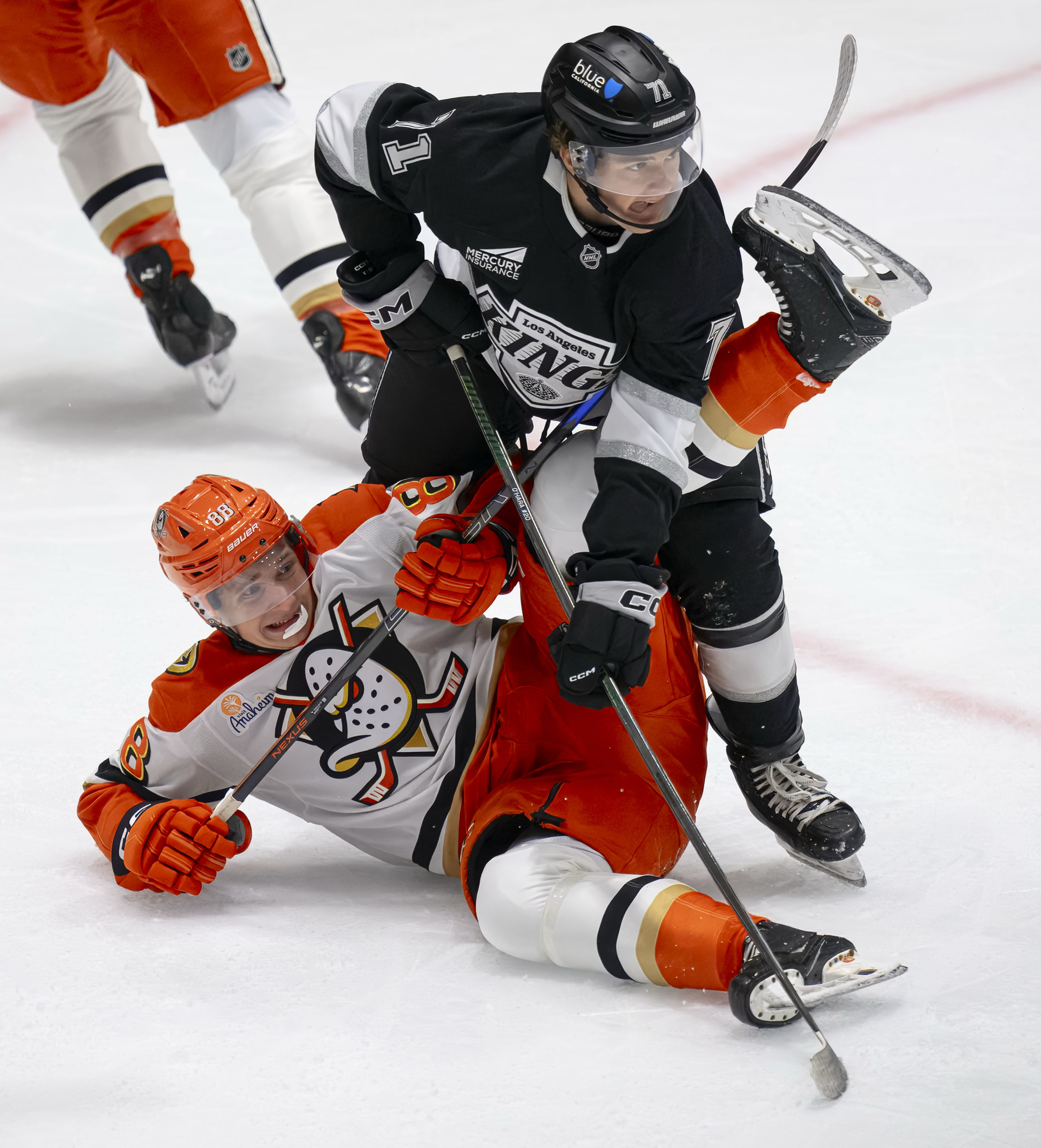 The Ducks’ Darels Uljanskis, left, falls as the Kings’ Ryan...