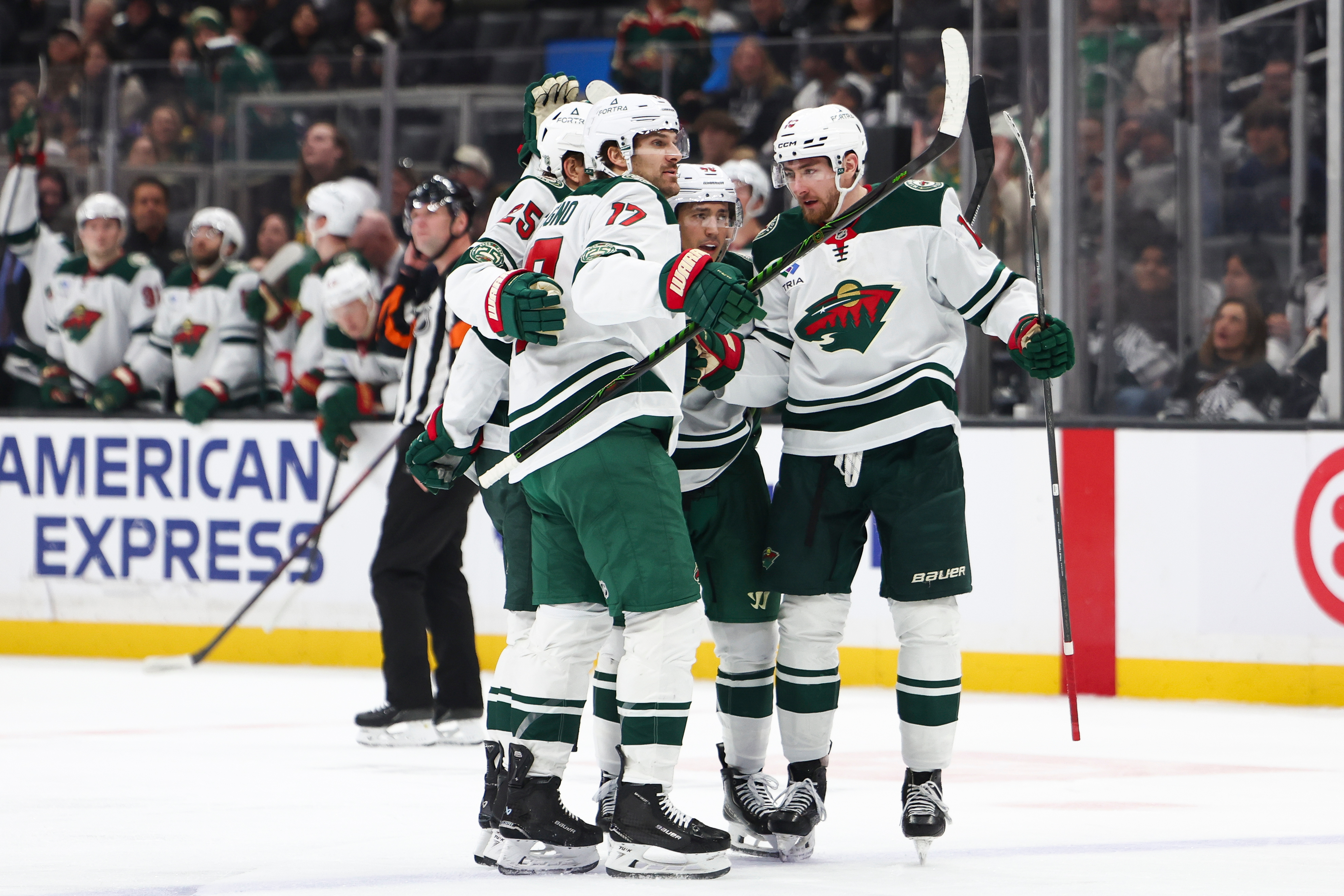 Minnesota Wild defenseman Jared Spurgeon, center, celebrates with left wing...