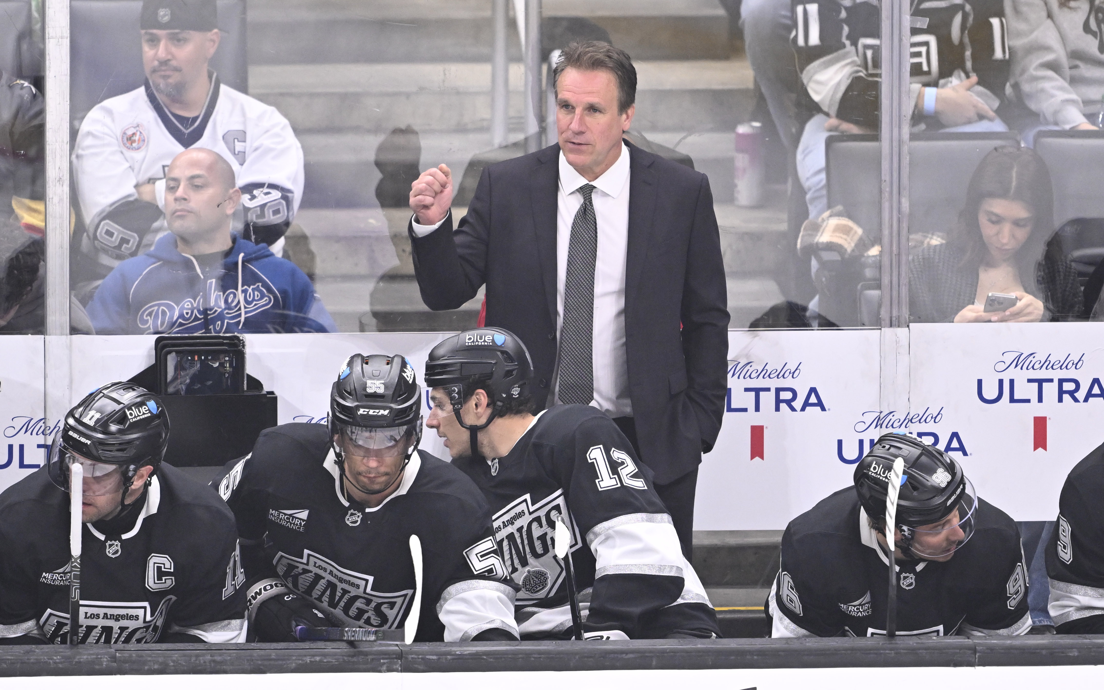 Kings head coach Jim Hiller looks on from the bench...