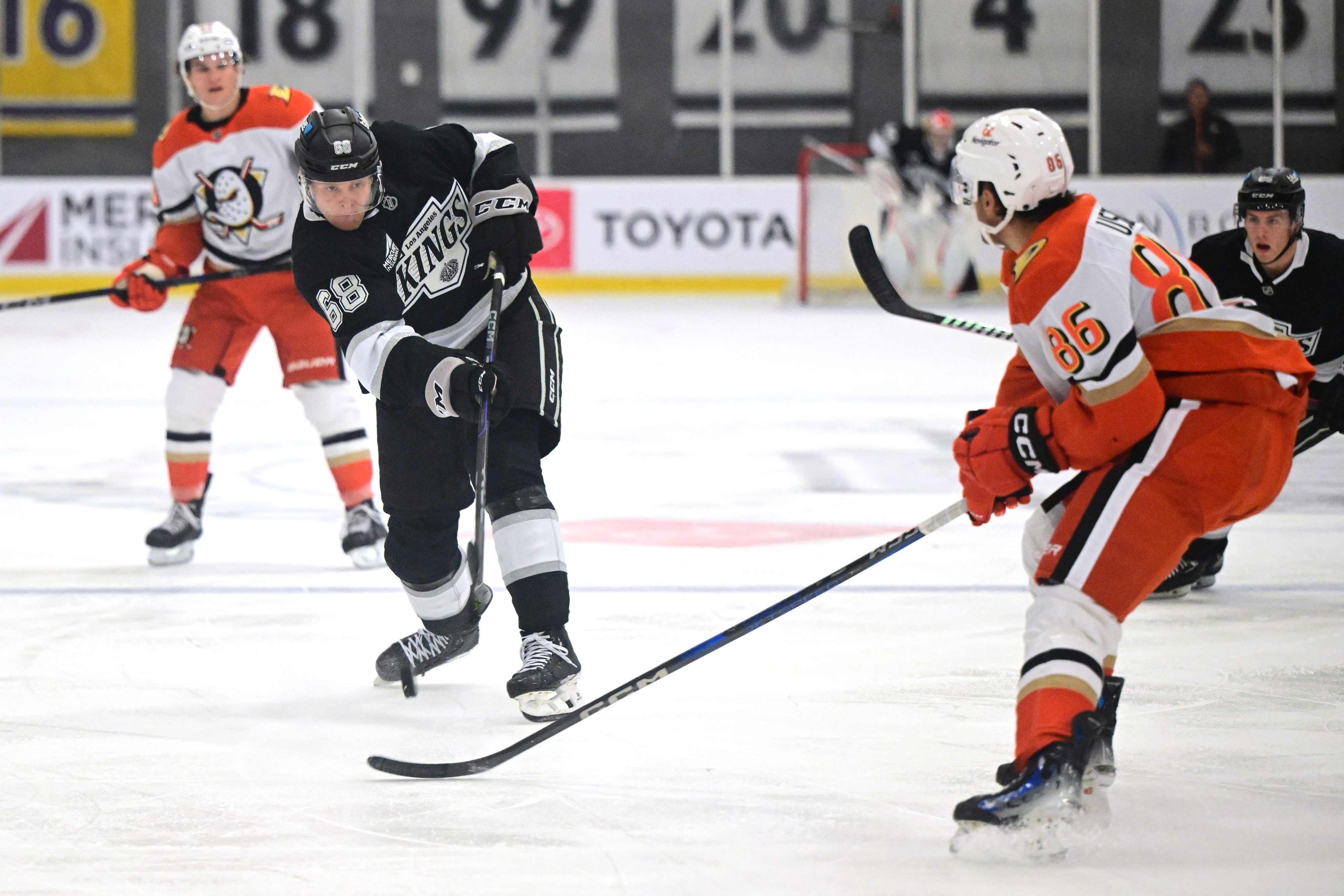 The Kings’ Arvid Caderoth, left, shoots the puck as the...
