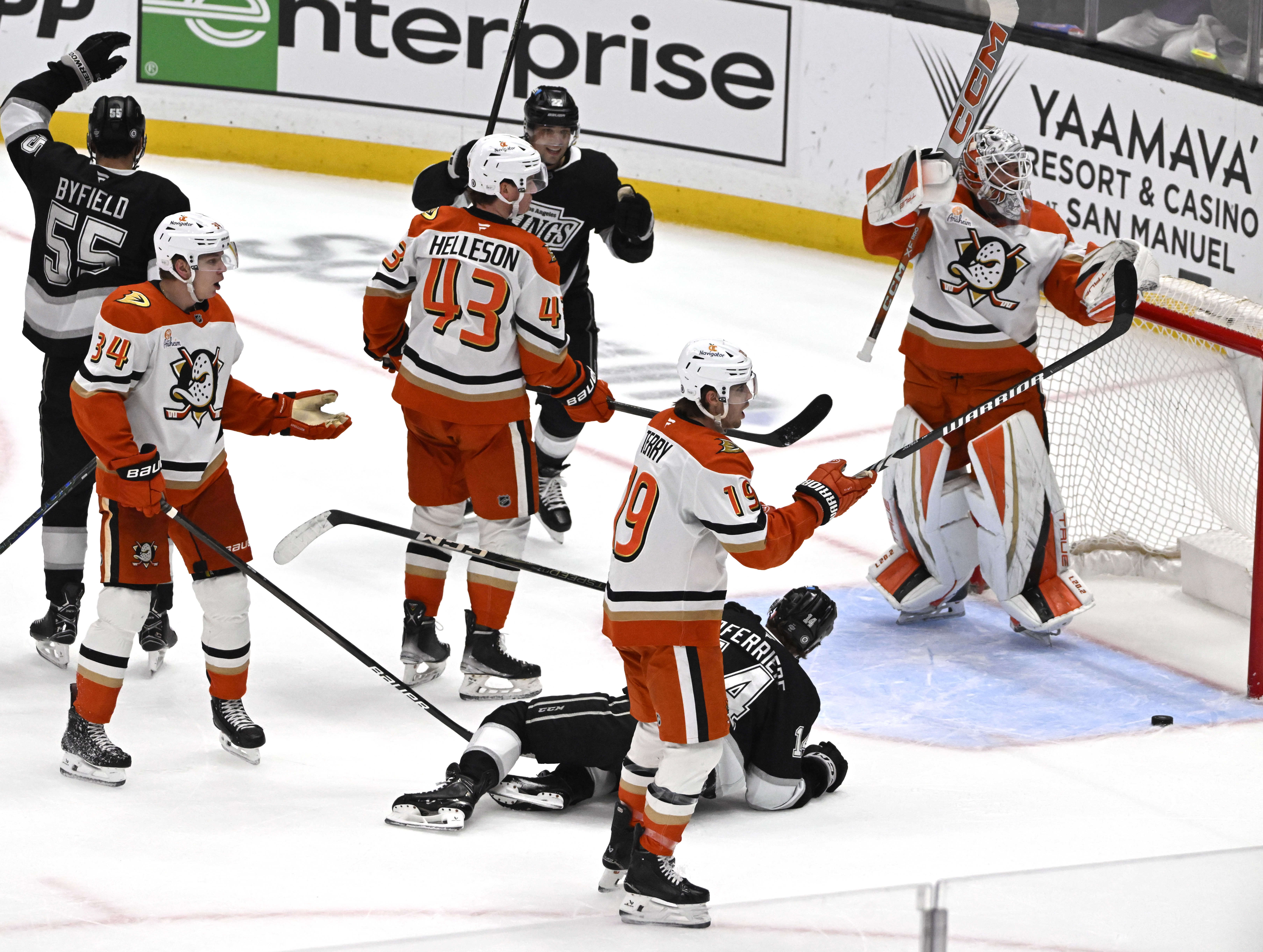 The Kings celebrate and the Ducks show their frustration after...