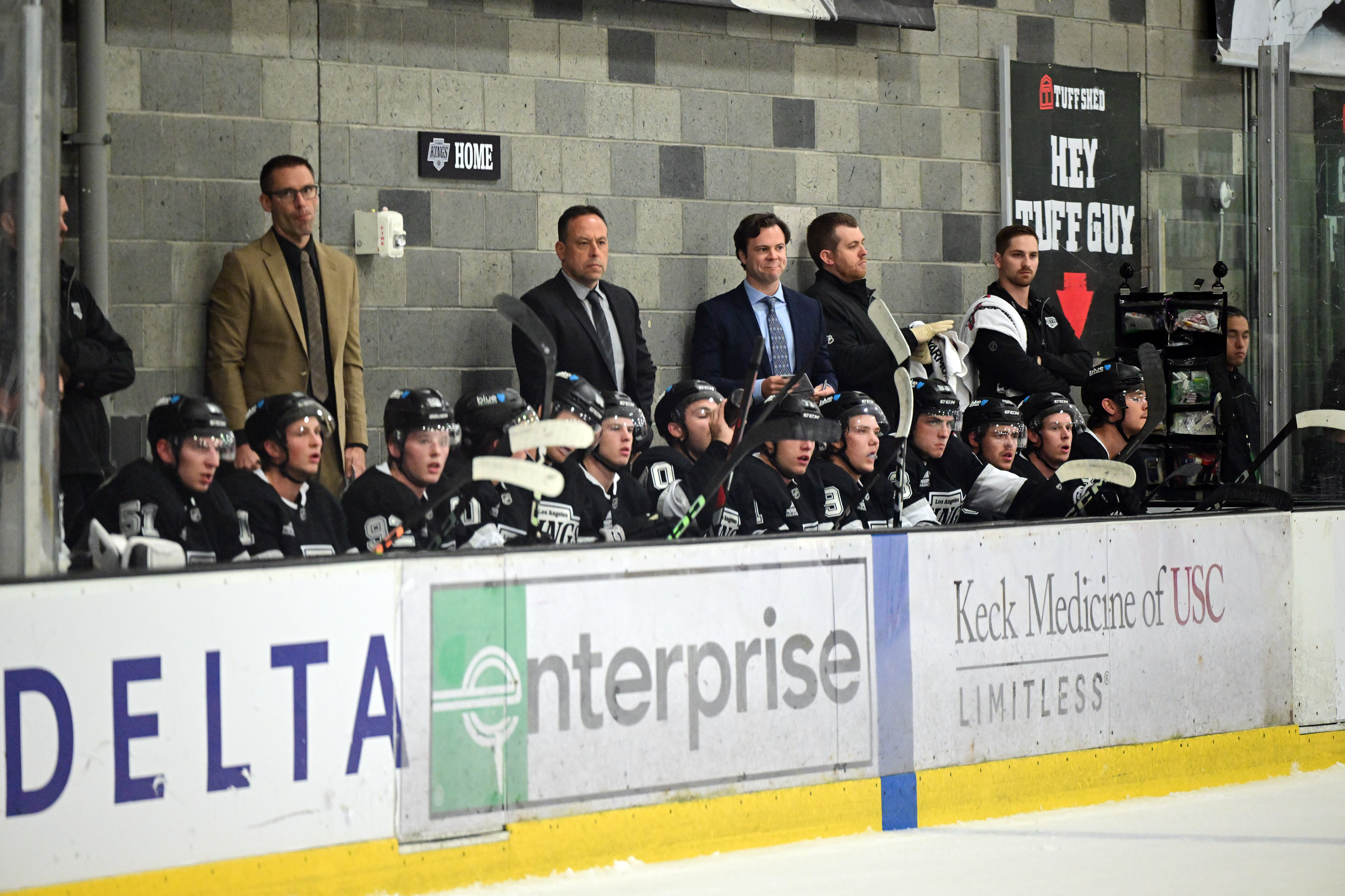 Kings players and coaches watch from the bench during their...