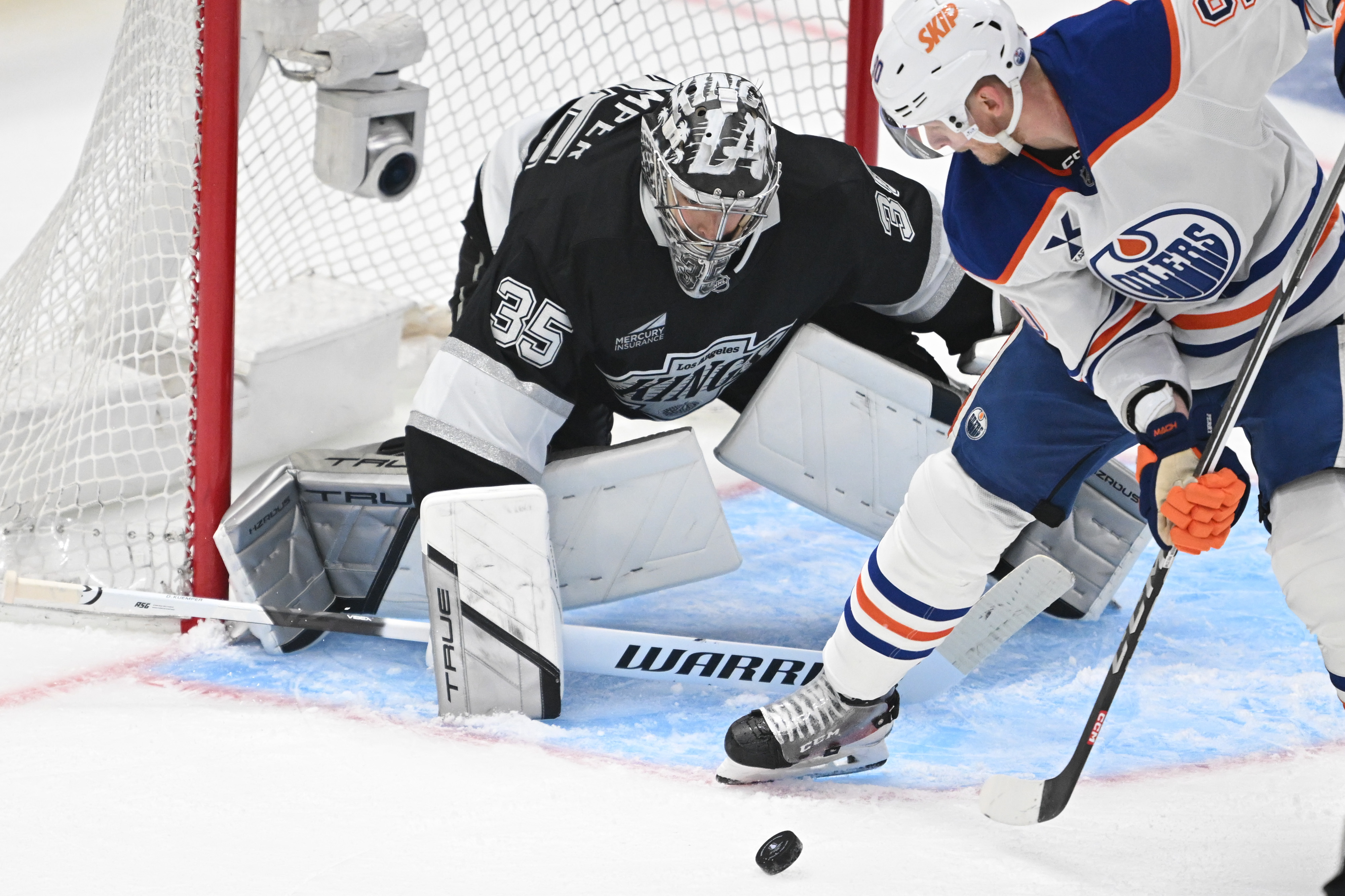 The Oilers’ Corey Perry tries to get the puck past...