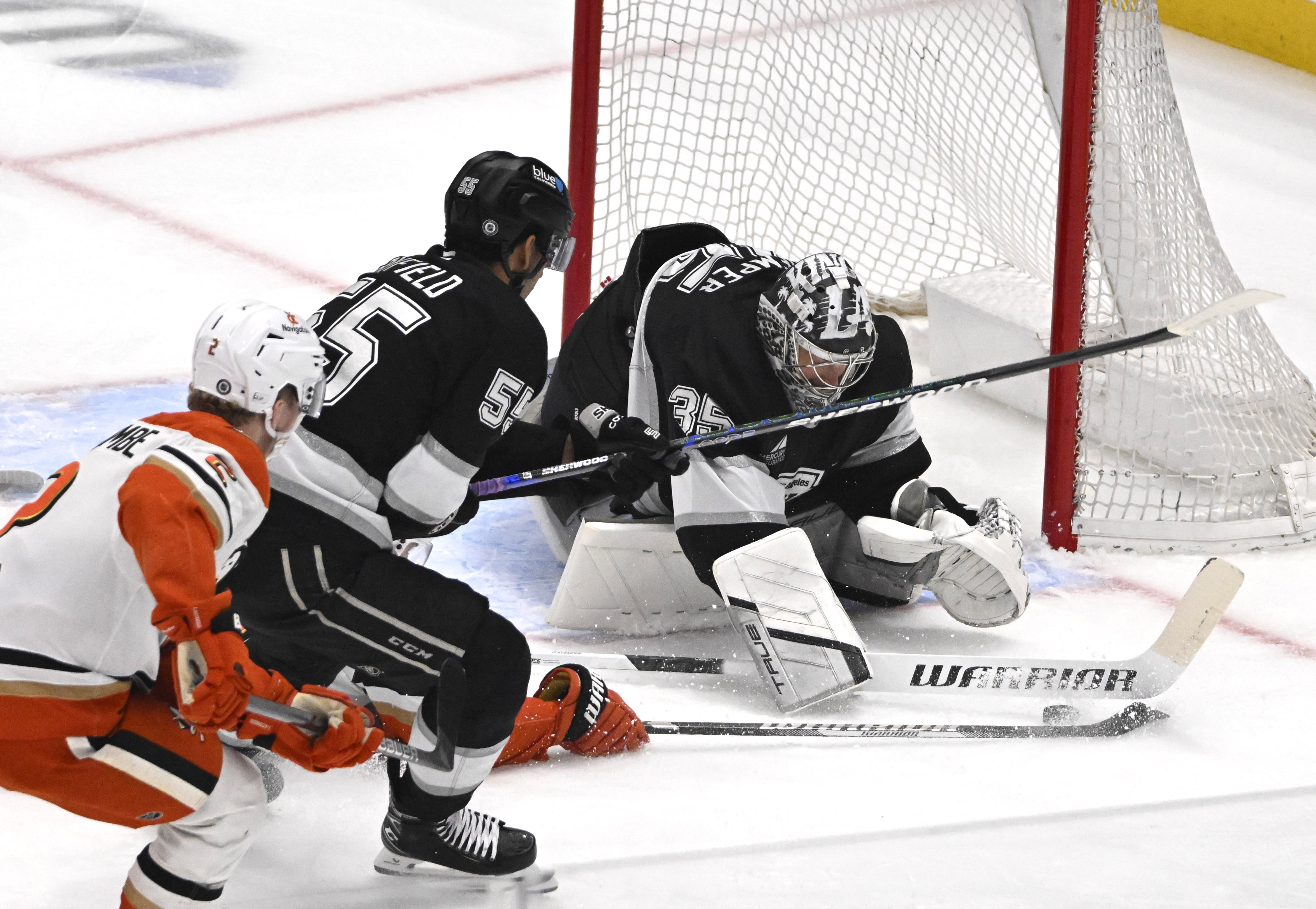 Kings goaltender Darcy Kuemper, right, blocks a shot by the...