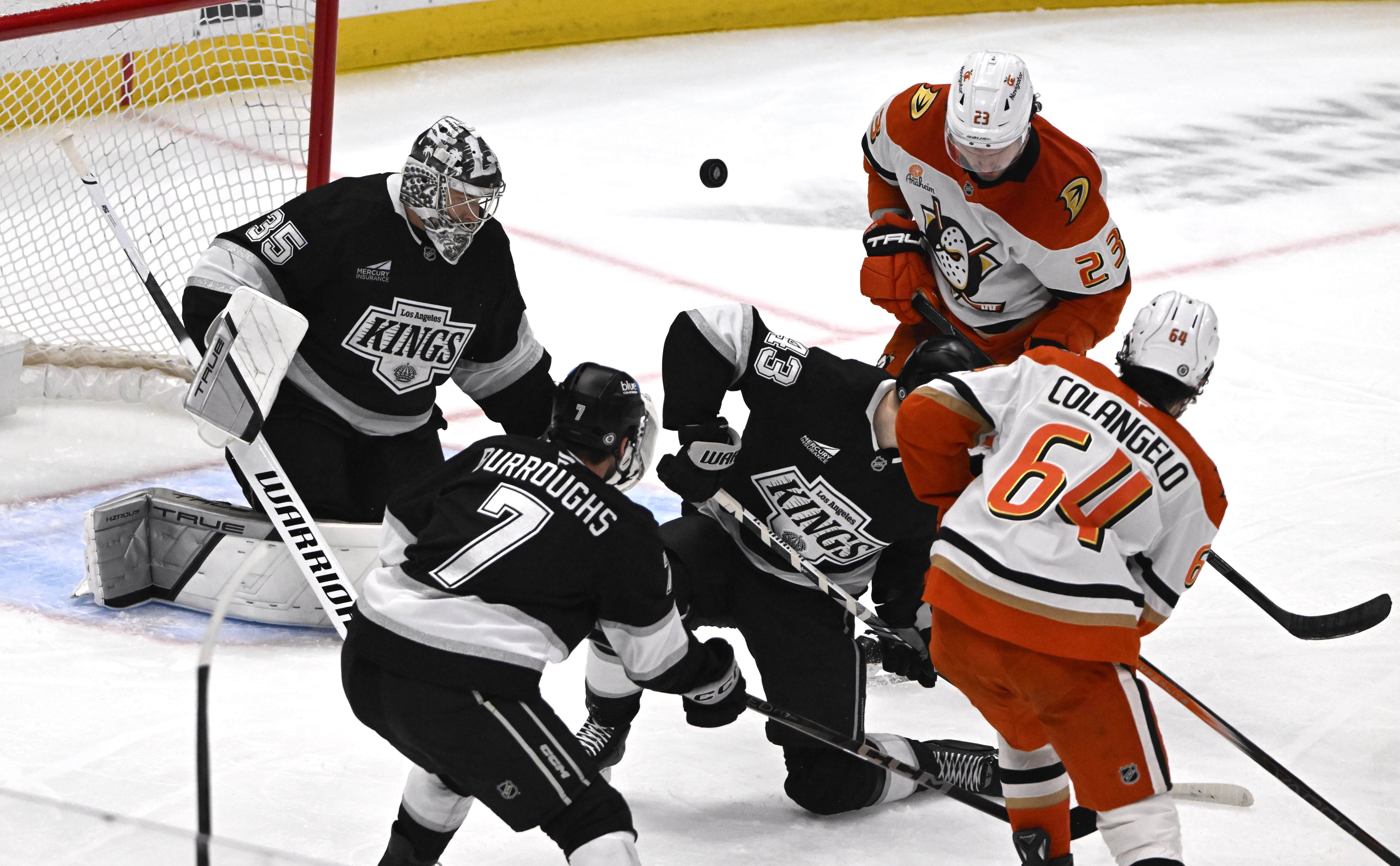 The Ducks’ Sam Colangelo (64) takes a shot as Kings...