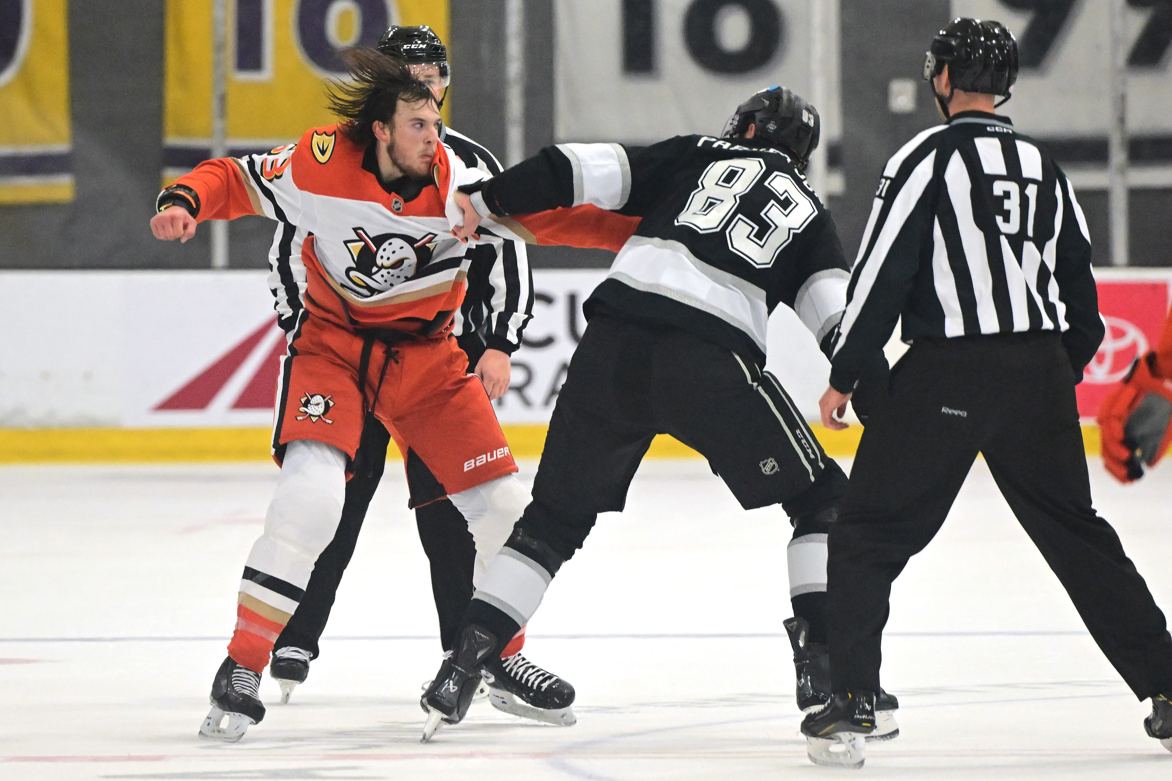The Ducks’ Konnor Smith, left, and the Kings’ John Parker-Jones...