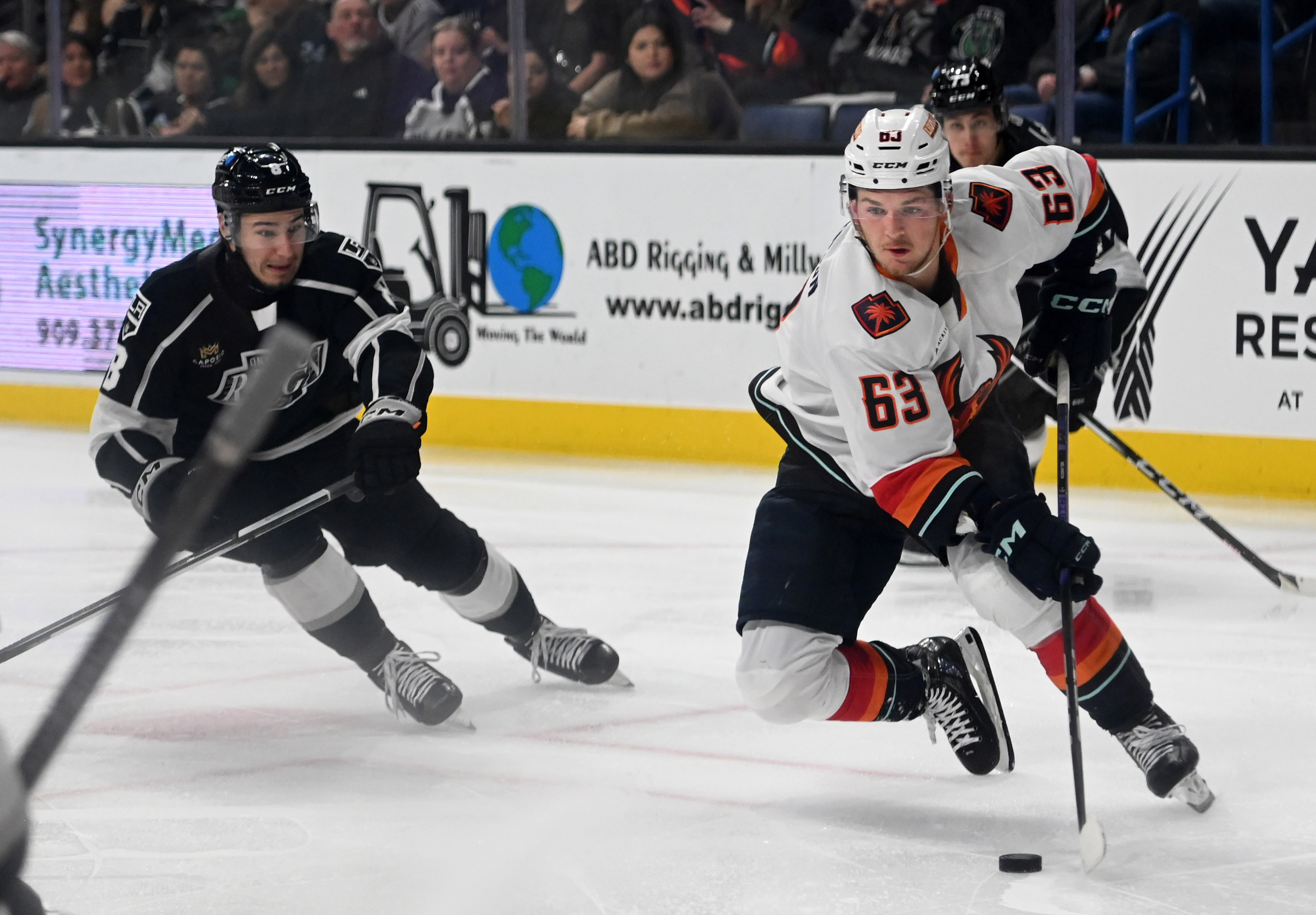 Coachella Valley Firebirds’ Jacob Melanson driblles guarded by Ontario Reign’s...