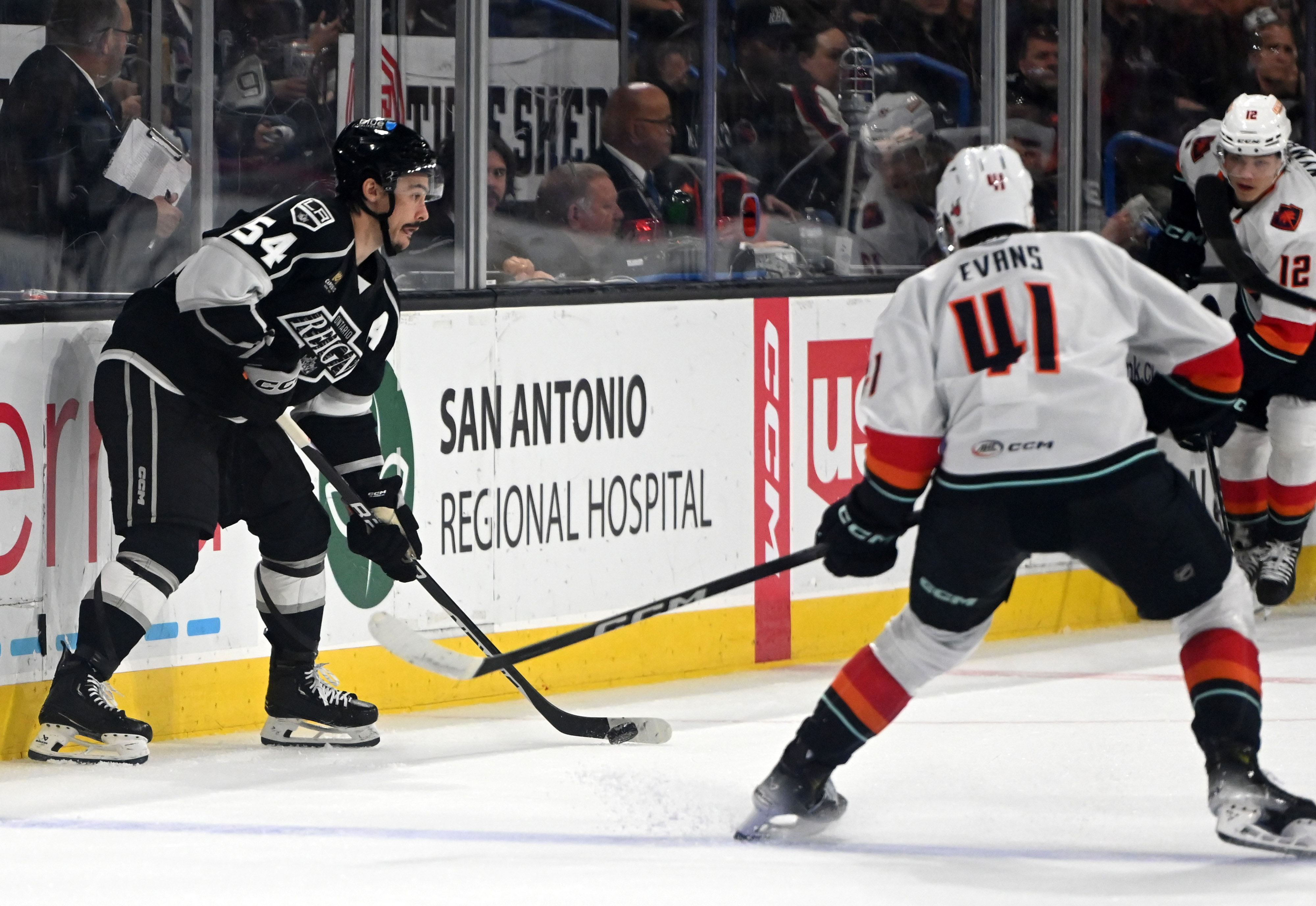 Ontario Reign’s Charles Hudon looks to pass guarded by Coachella...