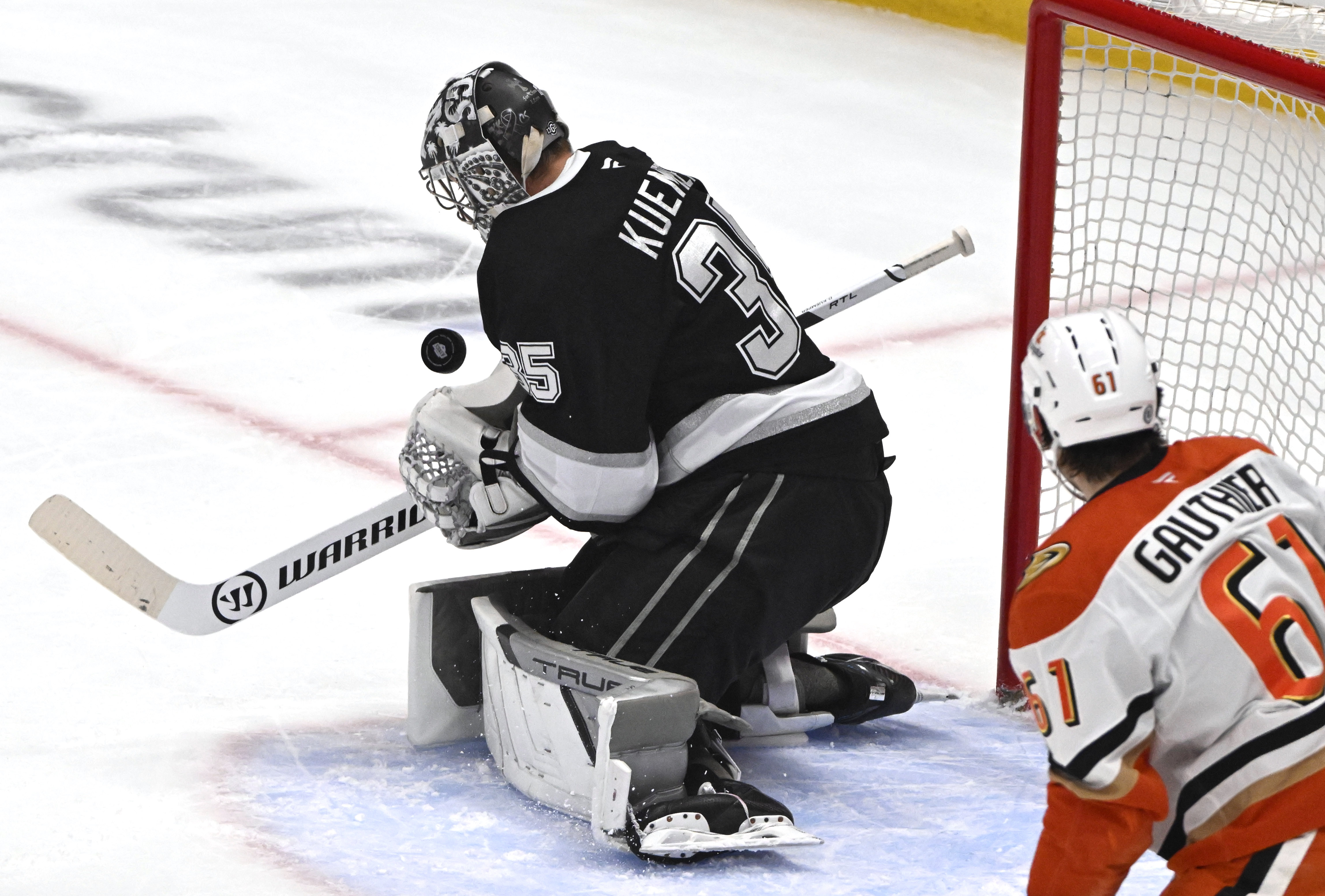 Kings goaltender Darcy Kuemper stops a shot as Ducks rookie...