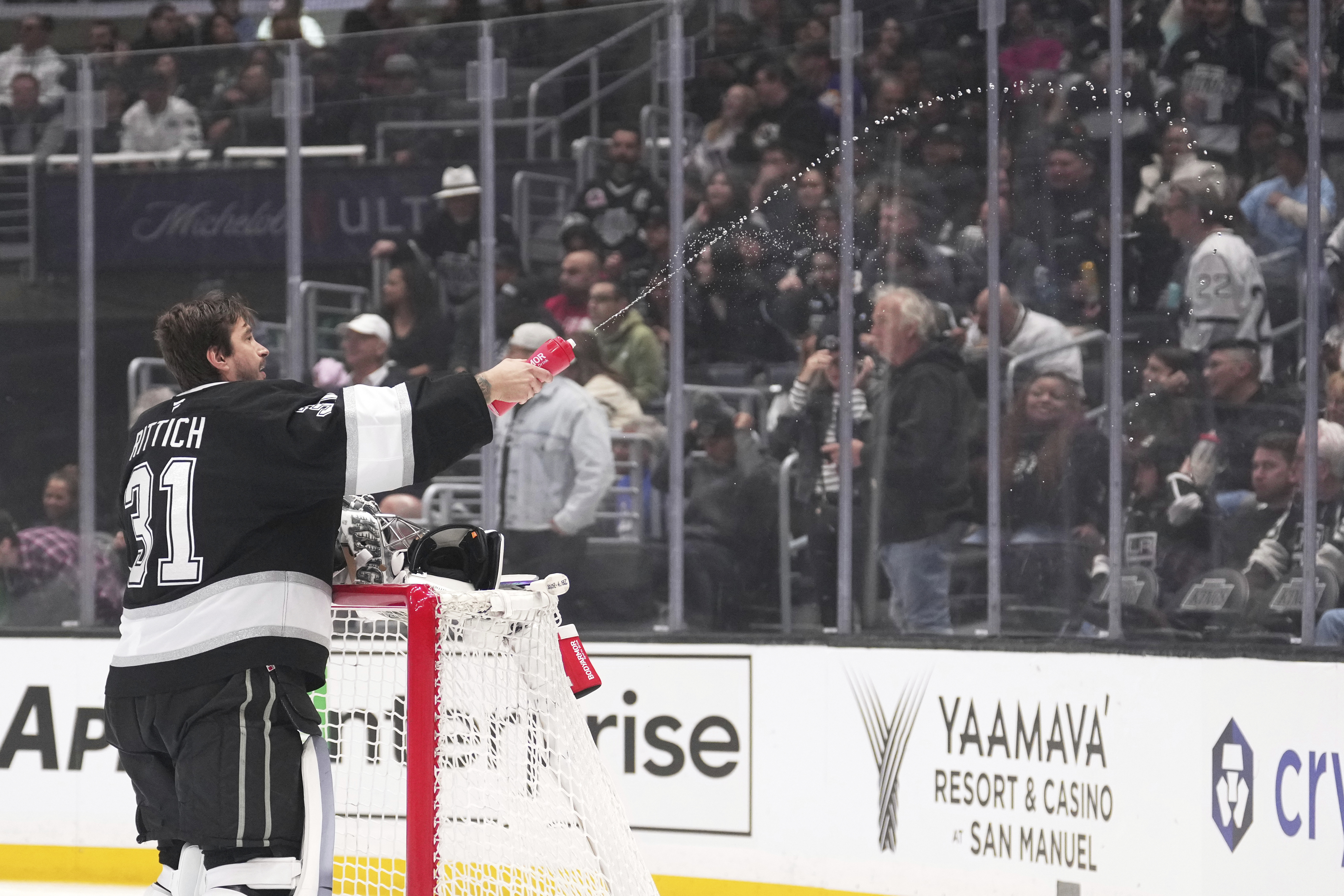 Kings goaltender David Rittich squirts water prior to an NHL...