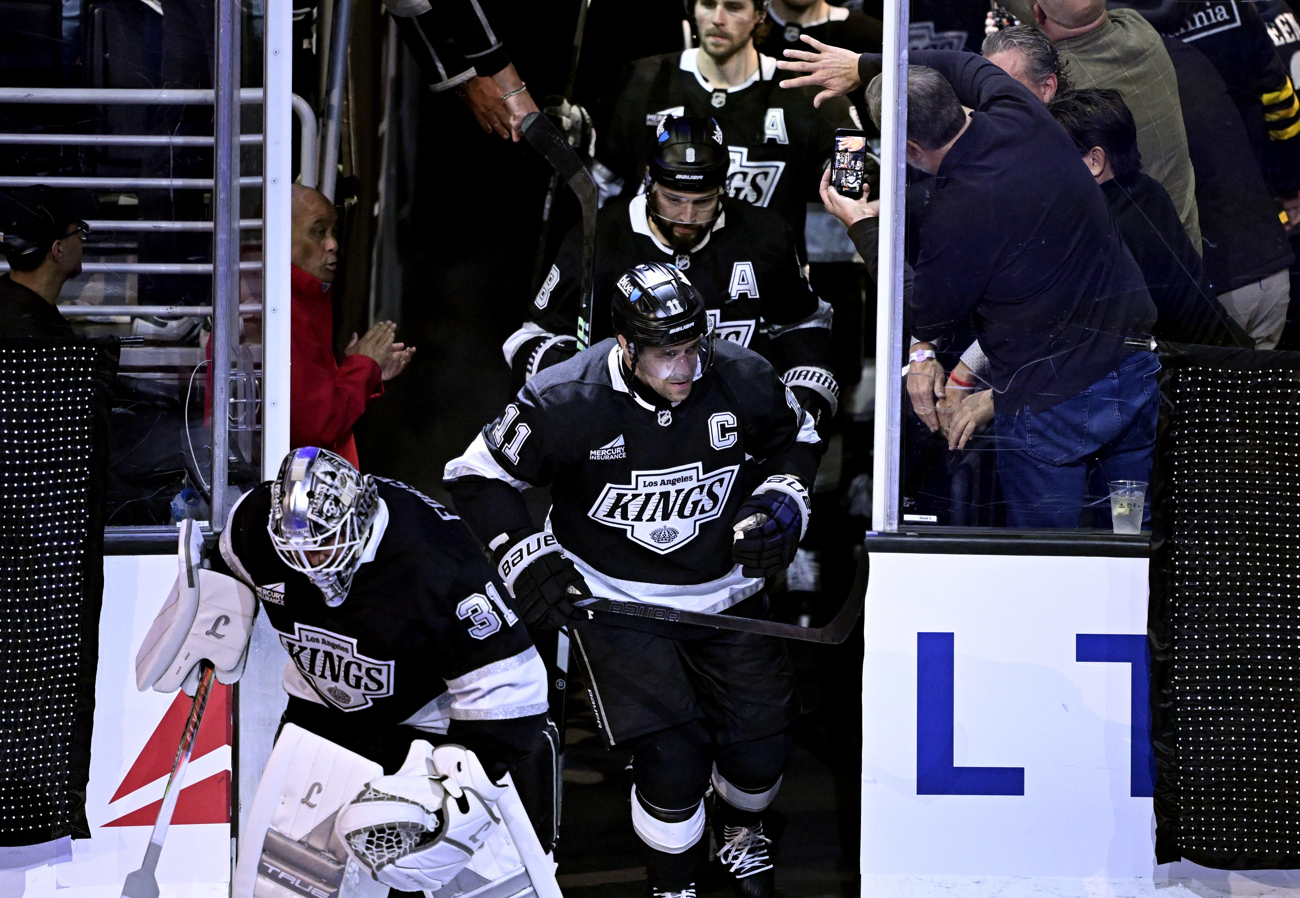 Kings captain Anze Kopitar (11) takes the ice with his...