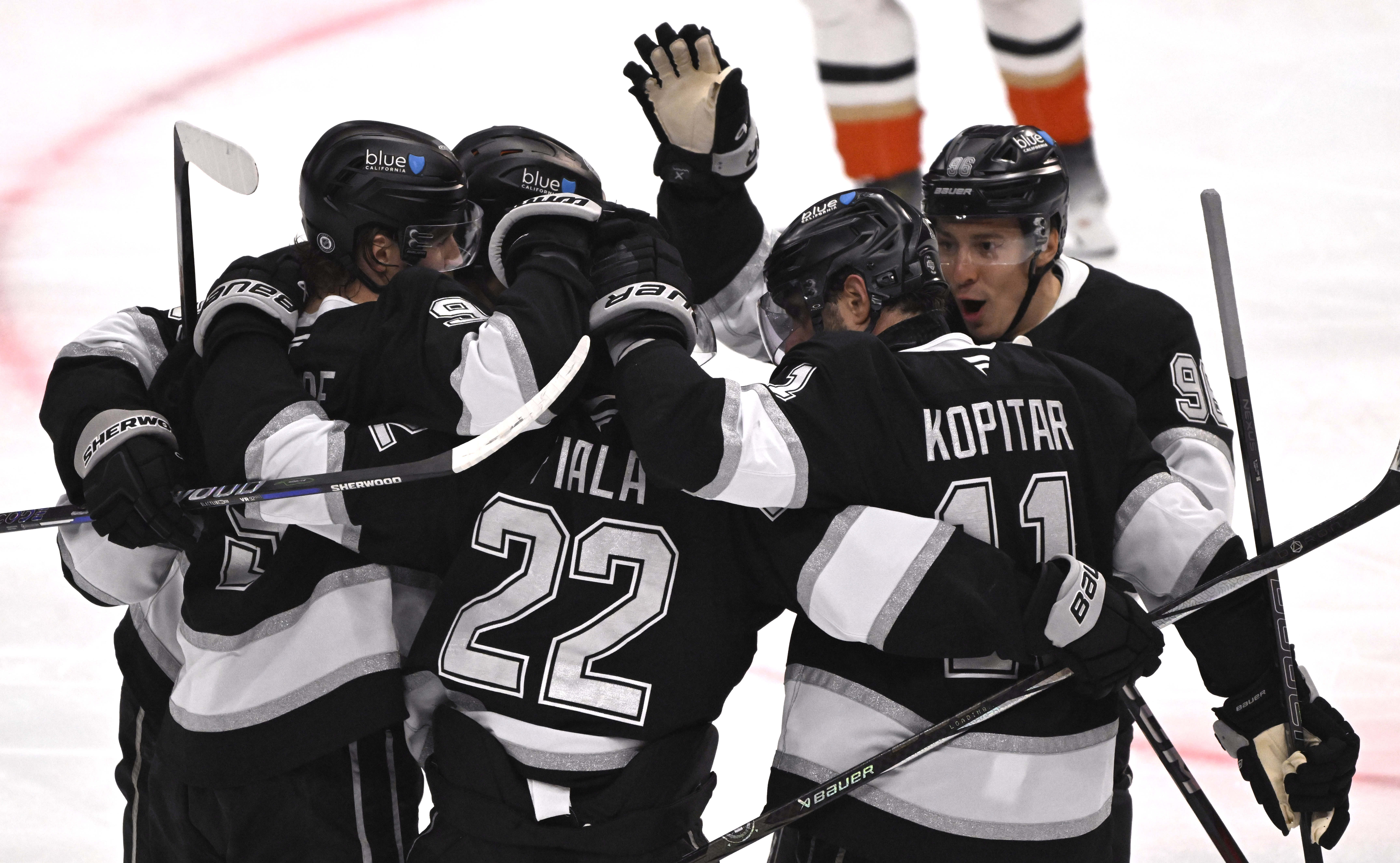 The Kings’ Kevin Fiala (22) celebrates with teammates after scoring...