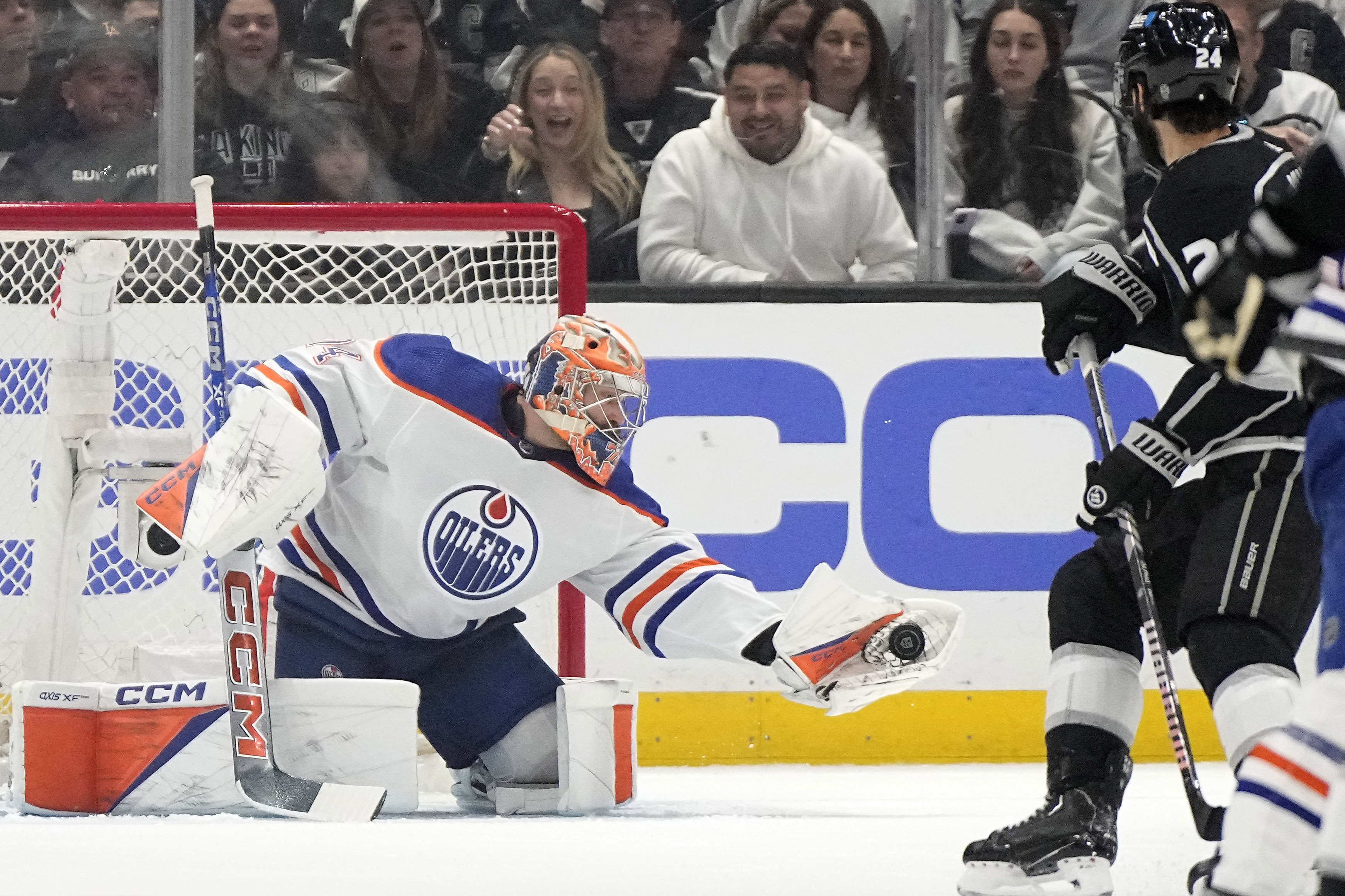 Edmonton Oilers goaltender Stuart Skinner, left, makes a glove save...