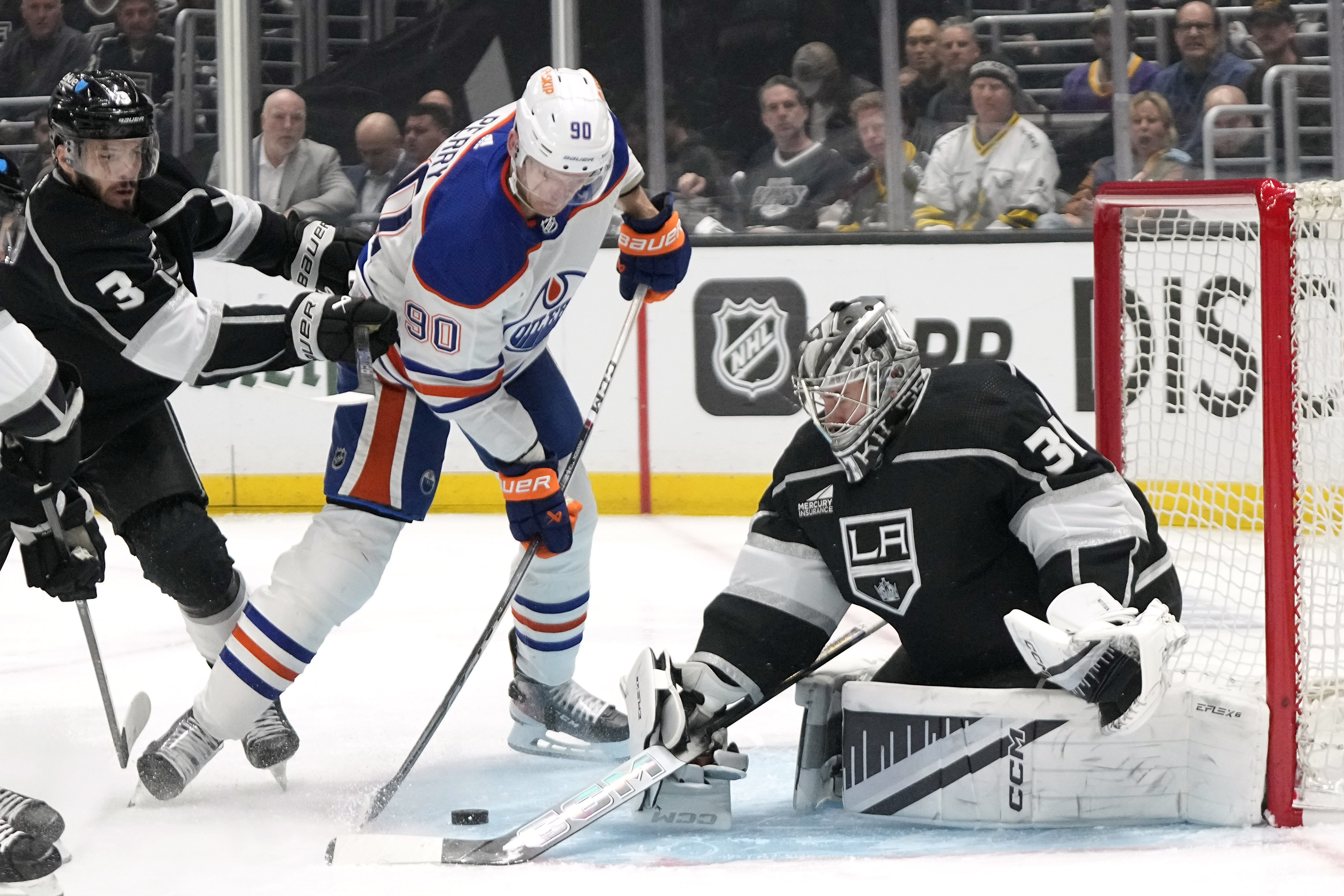 Edmonton Oilers right wing Corey Perry, center, tries to get...