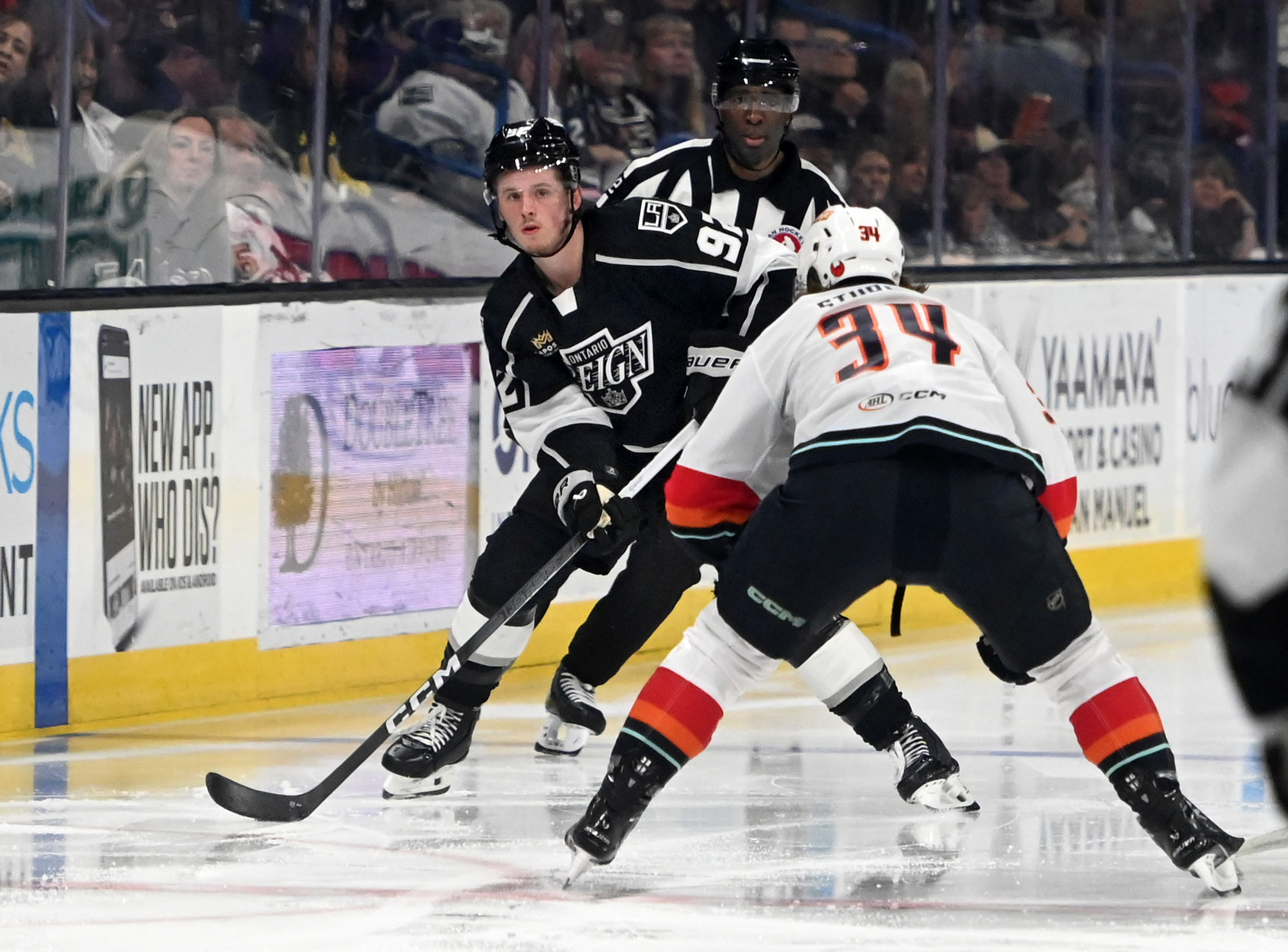 Ontario Reign’s Brandt Clarke looks for a pass guarded by...