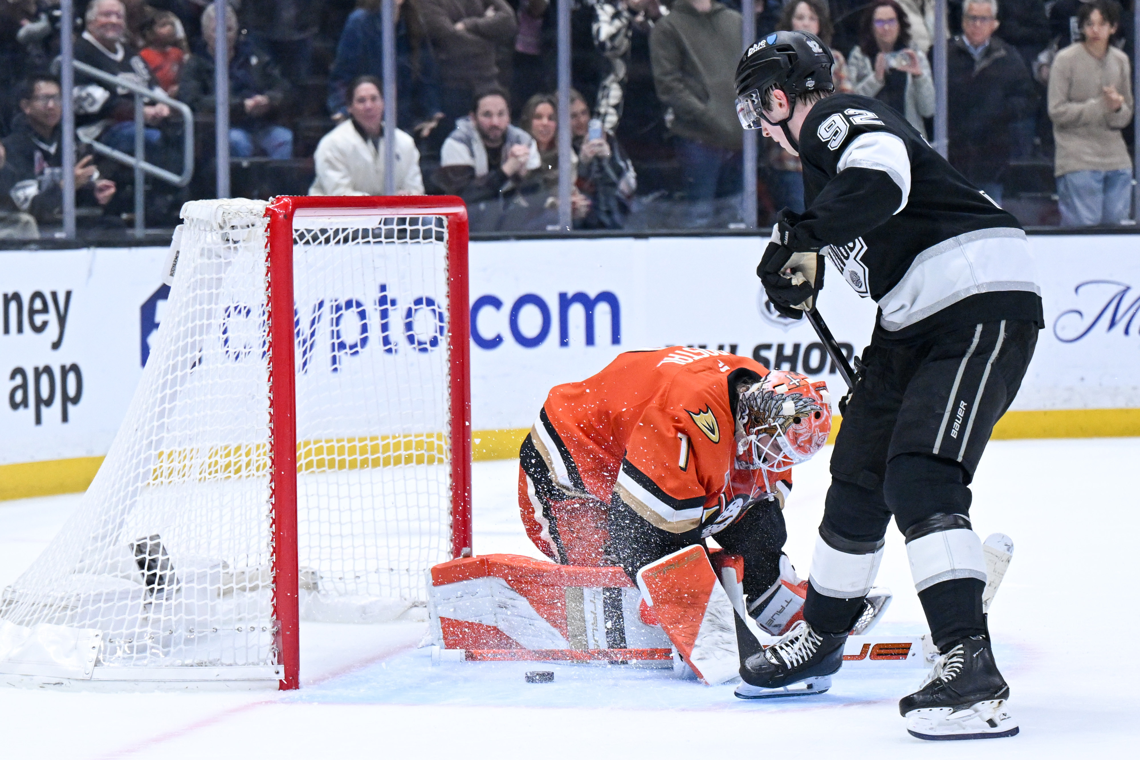 The Kings’ Brandt Clarke (92) scores on Ducks goaltender Lukas...