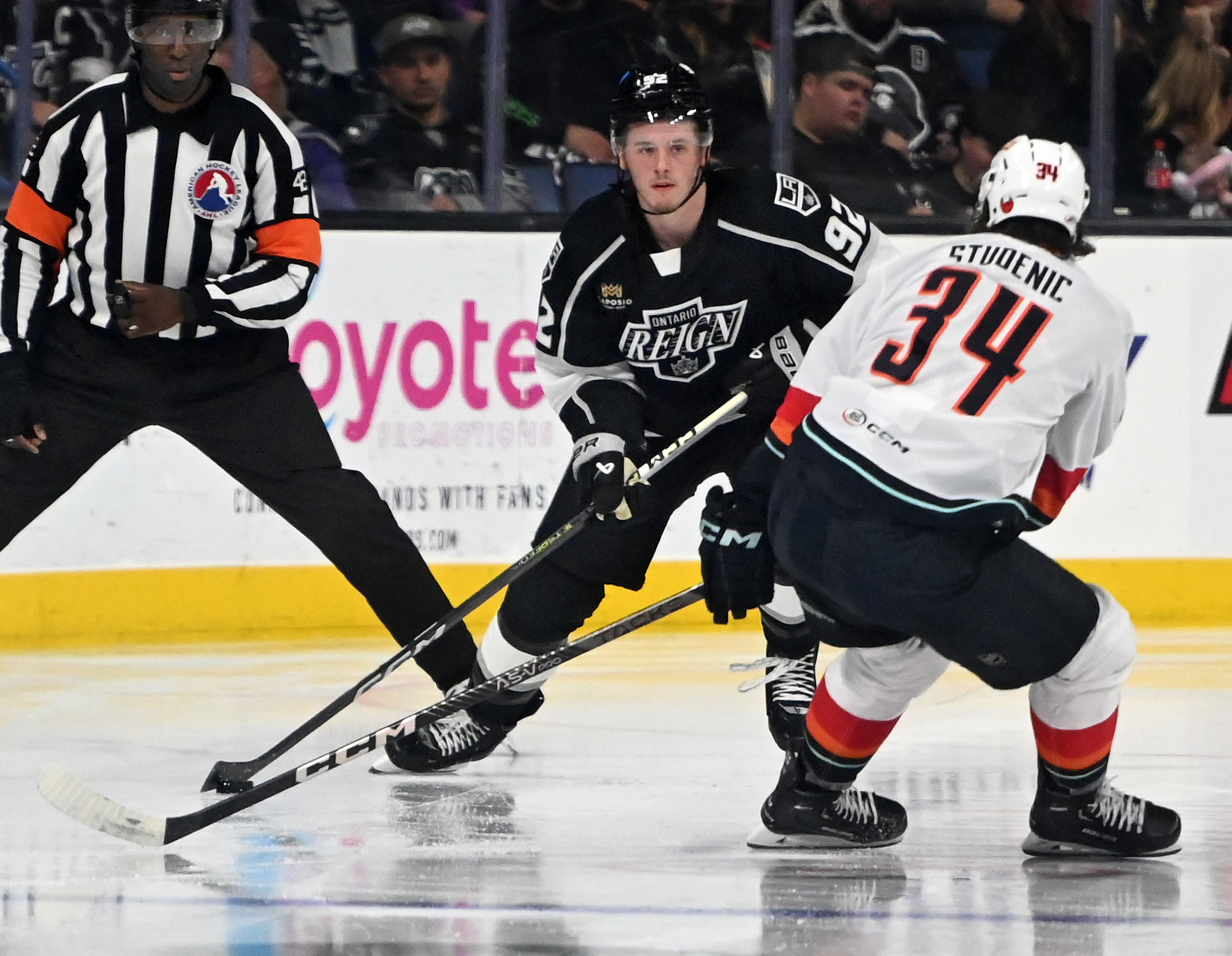 Ontario Reign’s Brandt Clarke looks for a pass guarded by...