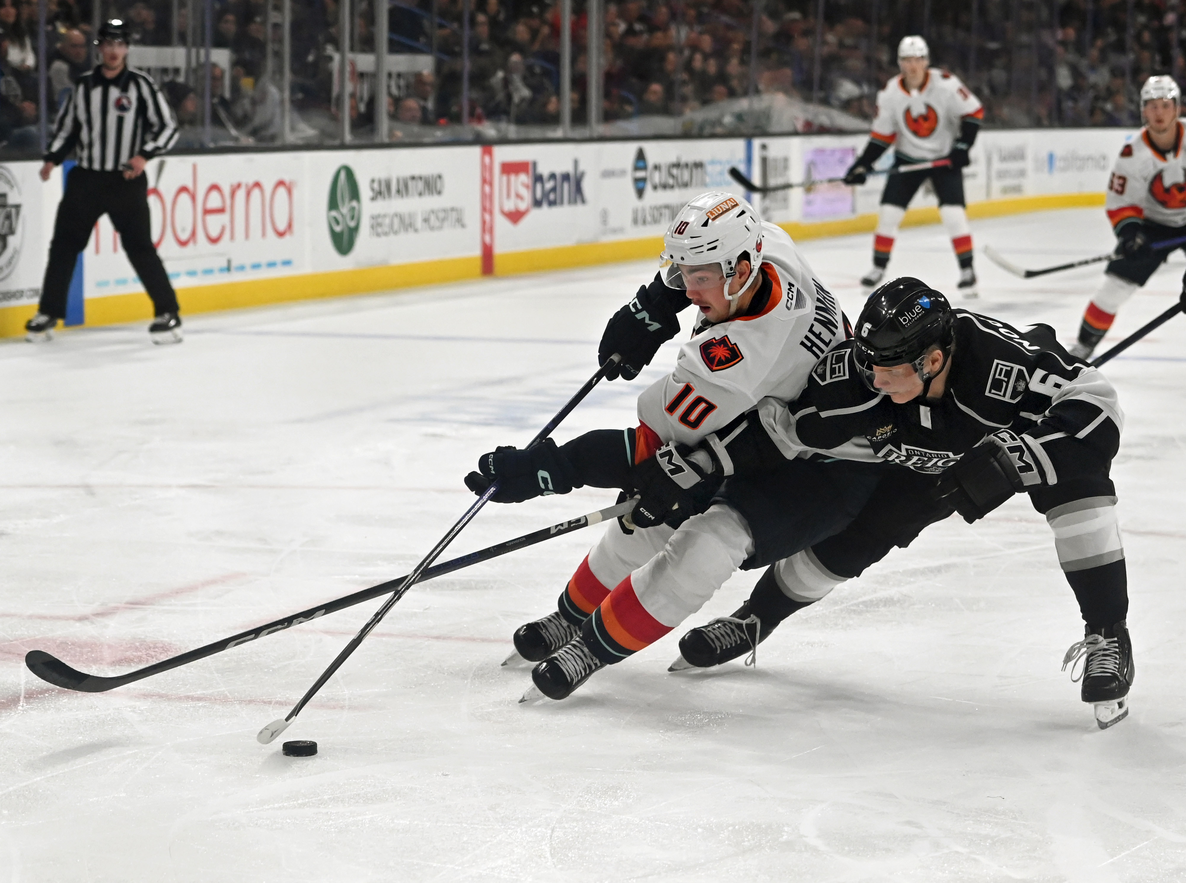 Coachella Valley Firebirds’ Luke Henman and Ontario Reign’s Kim Nousiainen...