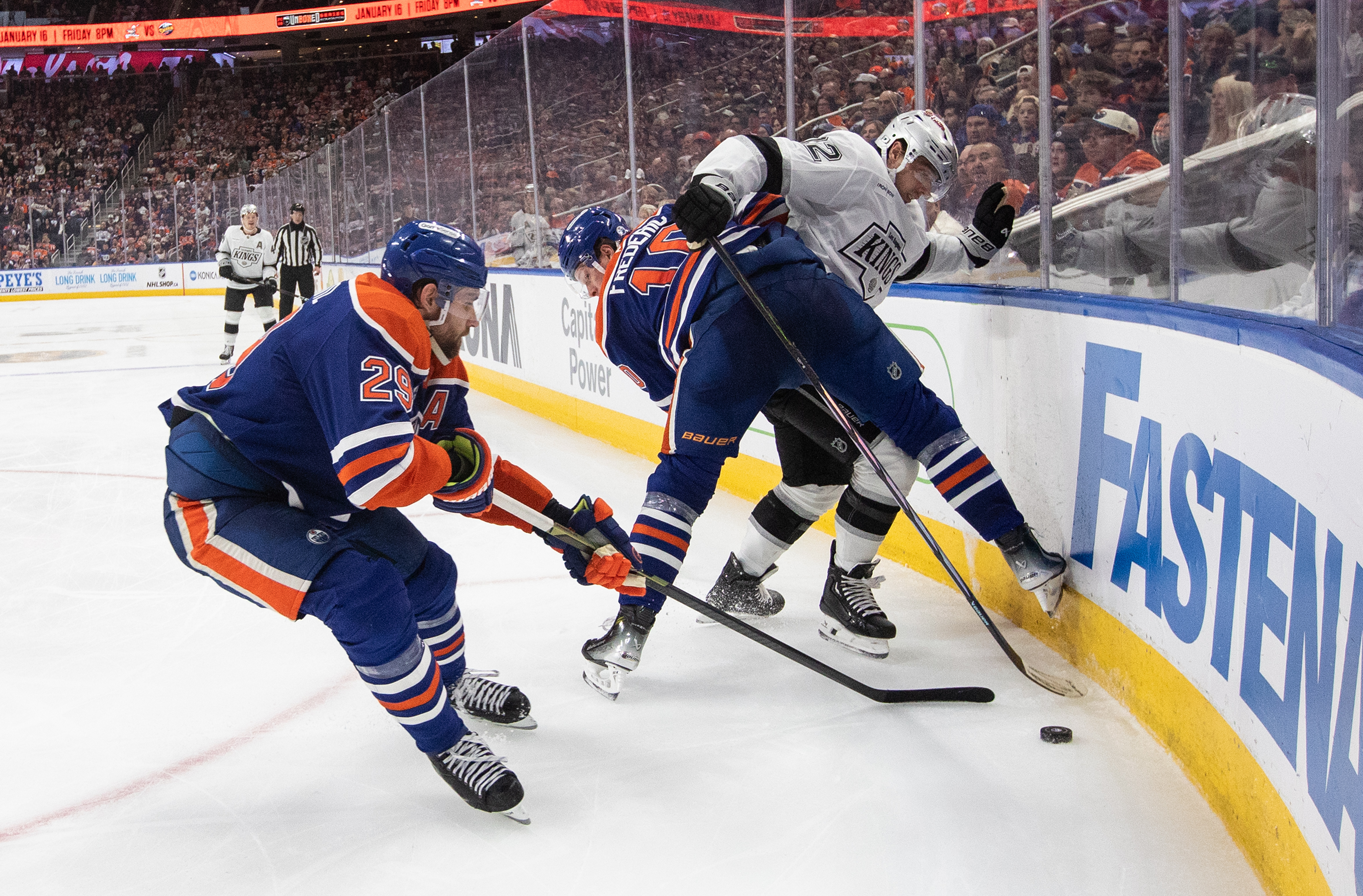 Kings’ Trevor Moore (12) and Edmonton Oilers’ Trent Frederic (10)...