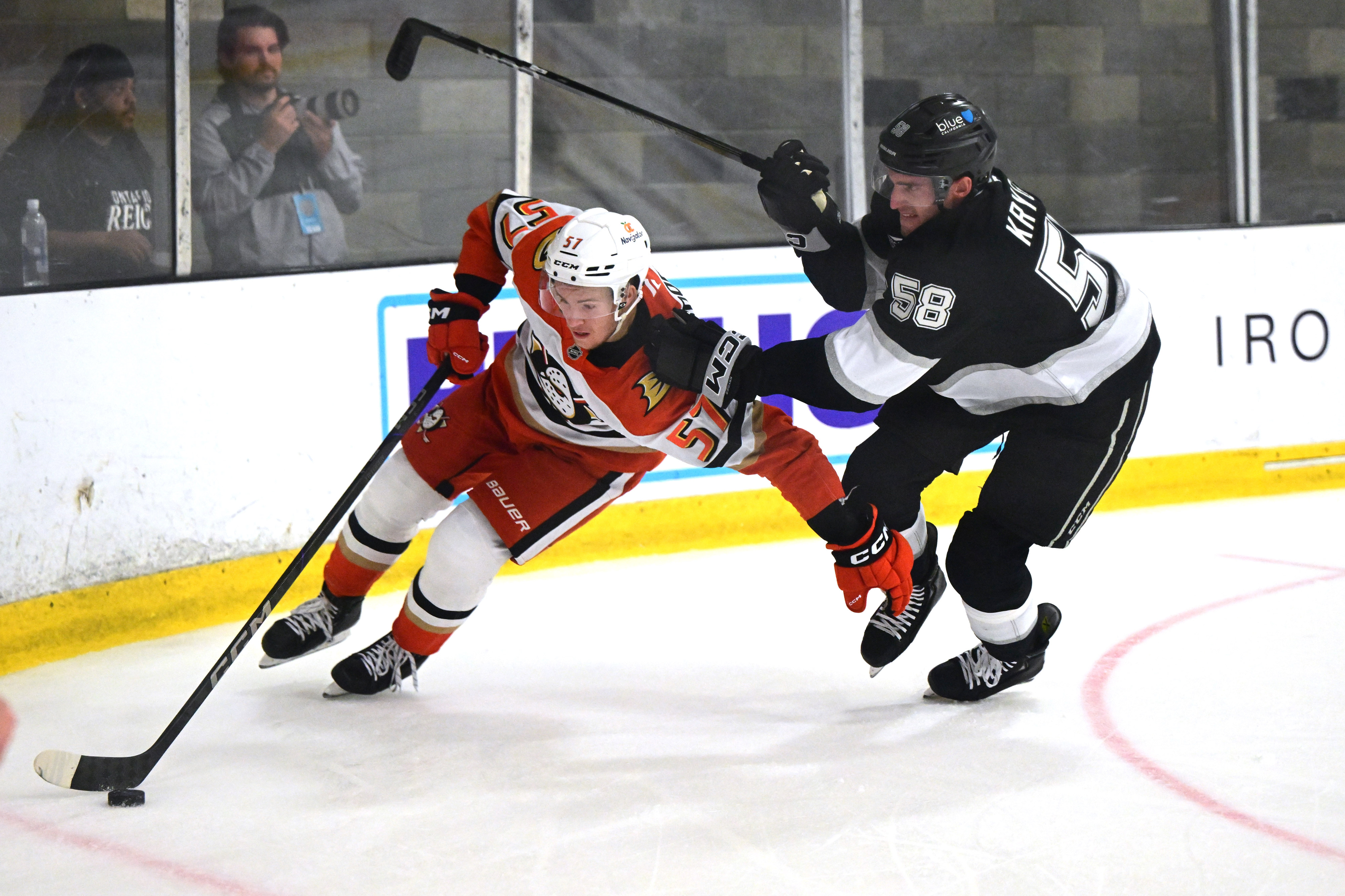The Ducks’ Yegor Sidorov, left, skates with the puck as...