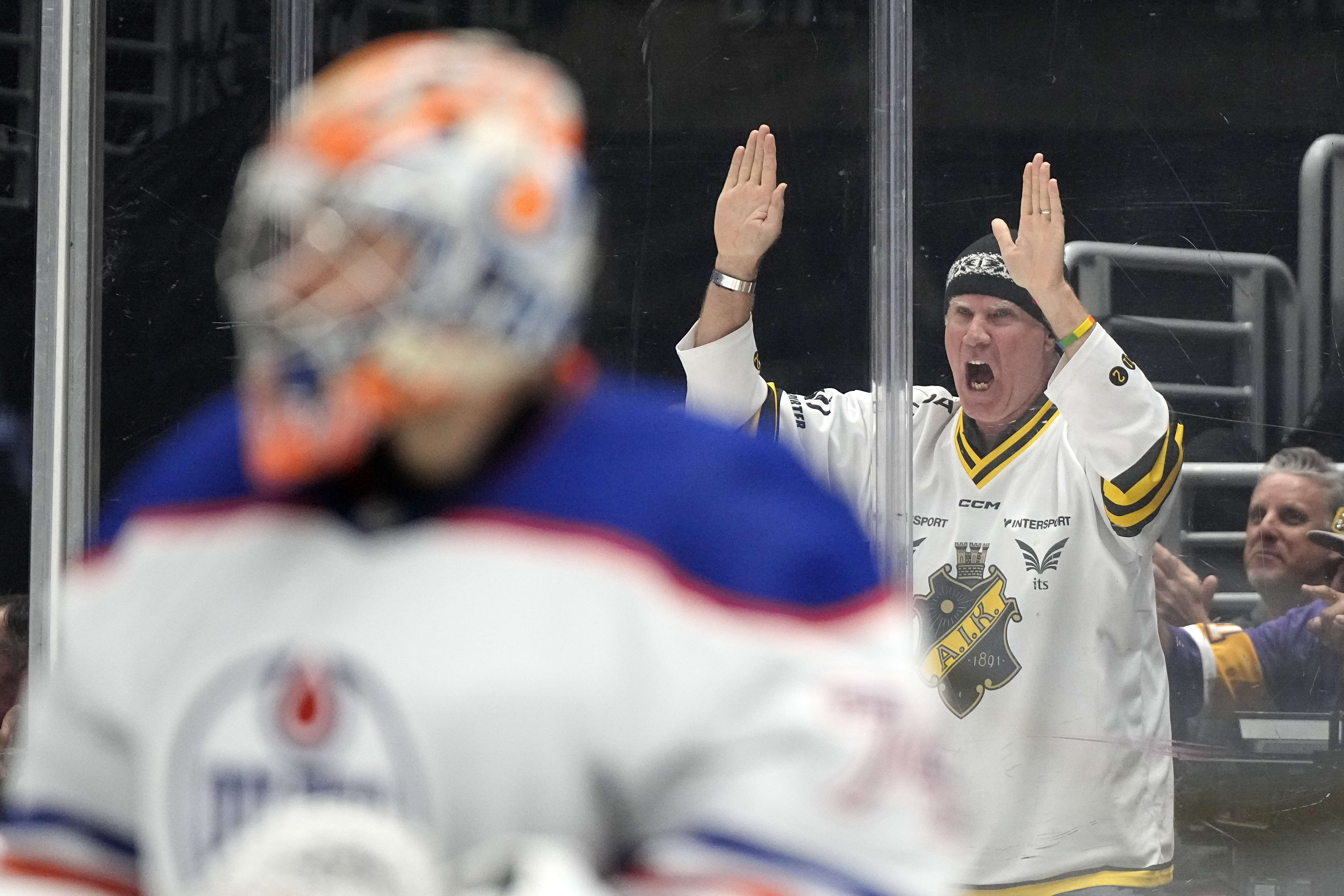 Actor Will Ferrell, right, cheers as Edmonton Oilers goaltender Stuart...