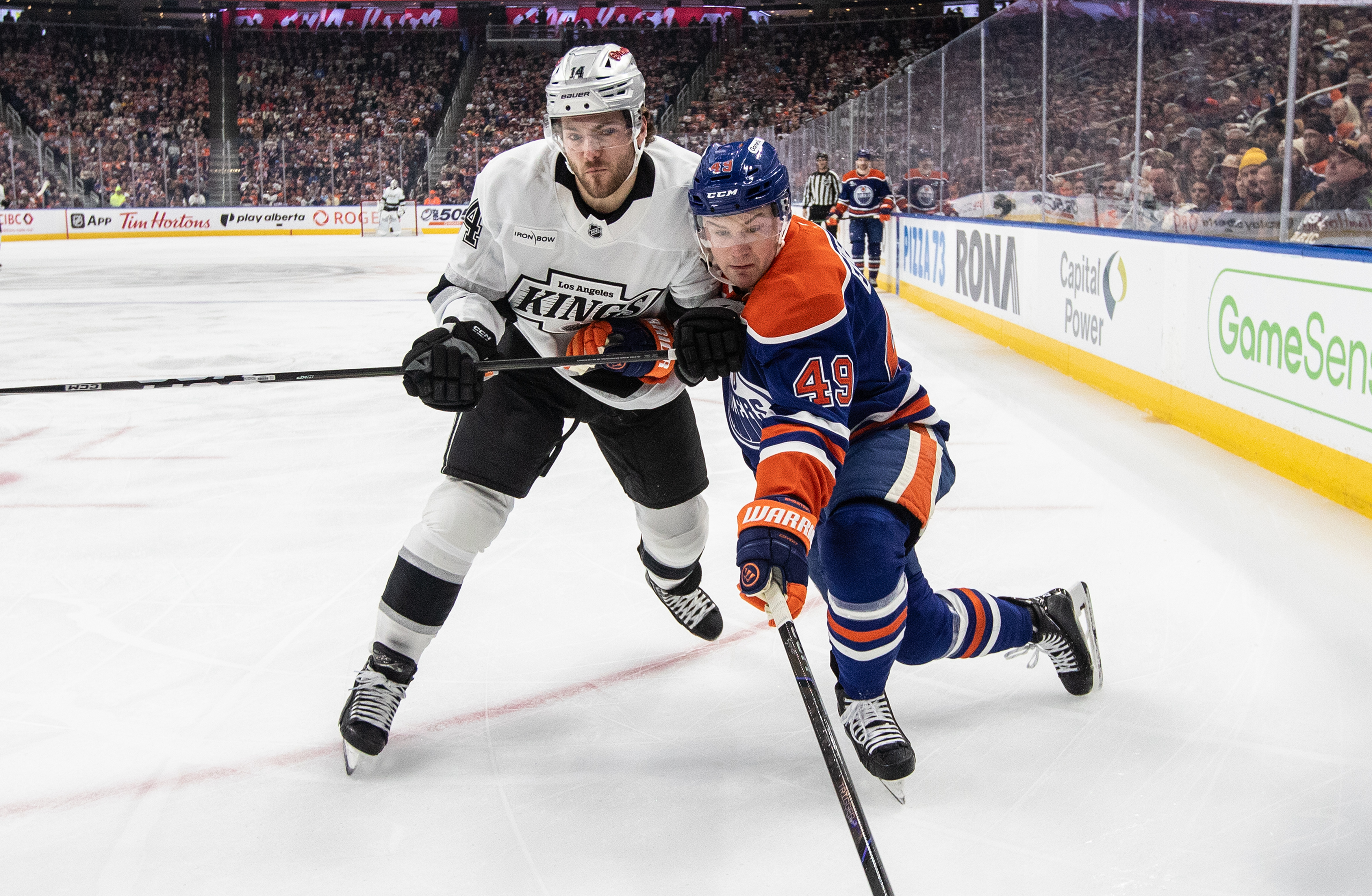 Kings’ Alex Laferriere (14) checks Edmonton Oilers’ Ty Emberson (49)...