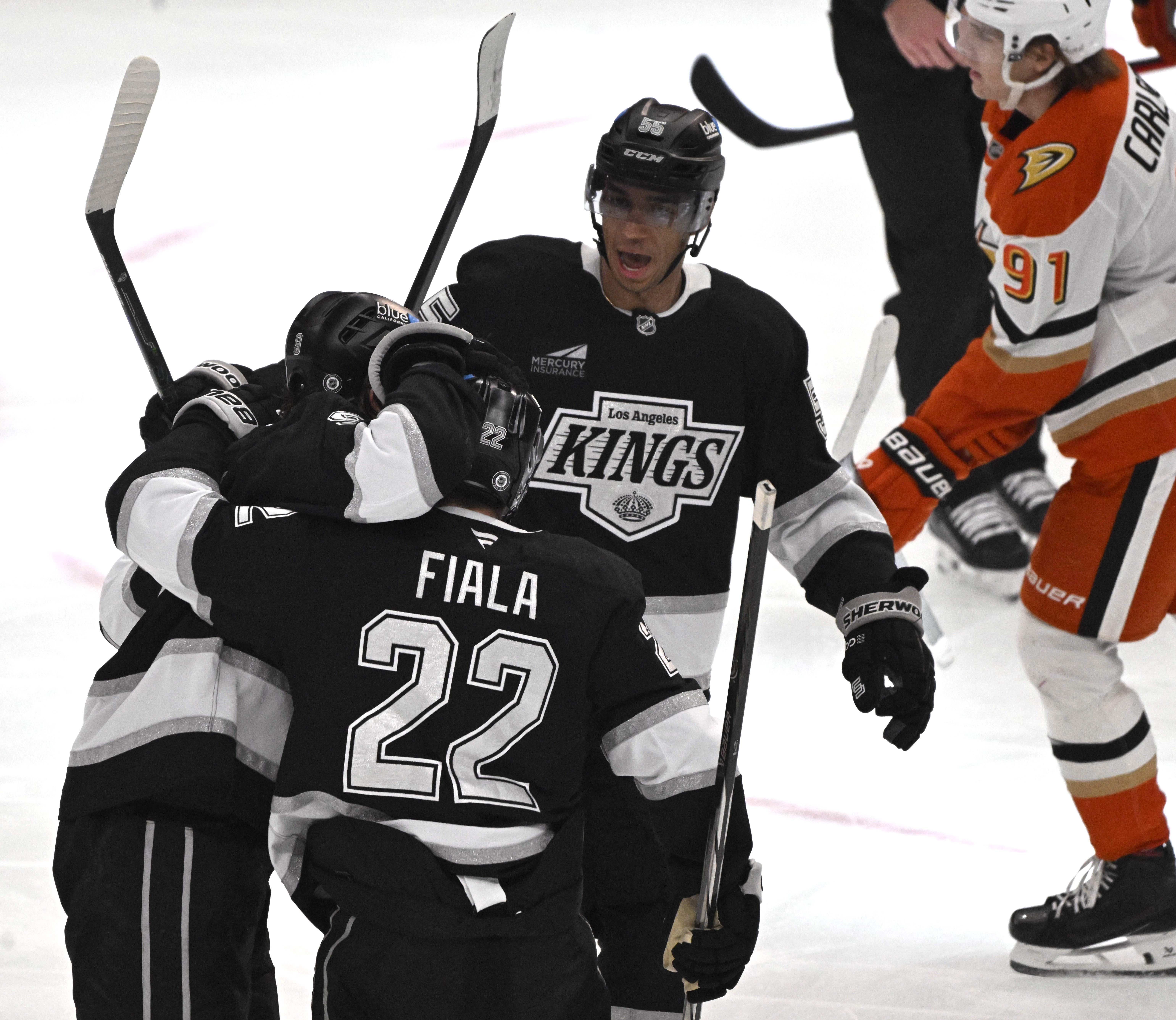 The Kings’ Kevin Fiala (22) celebrates with teammates after scoring...