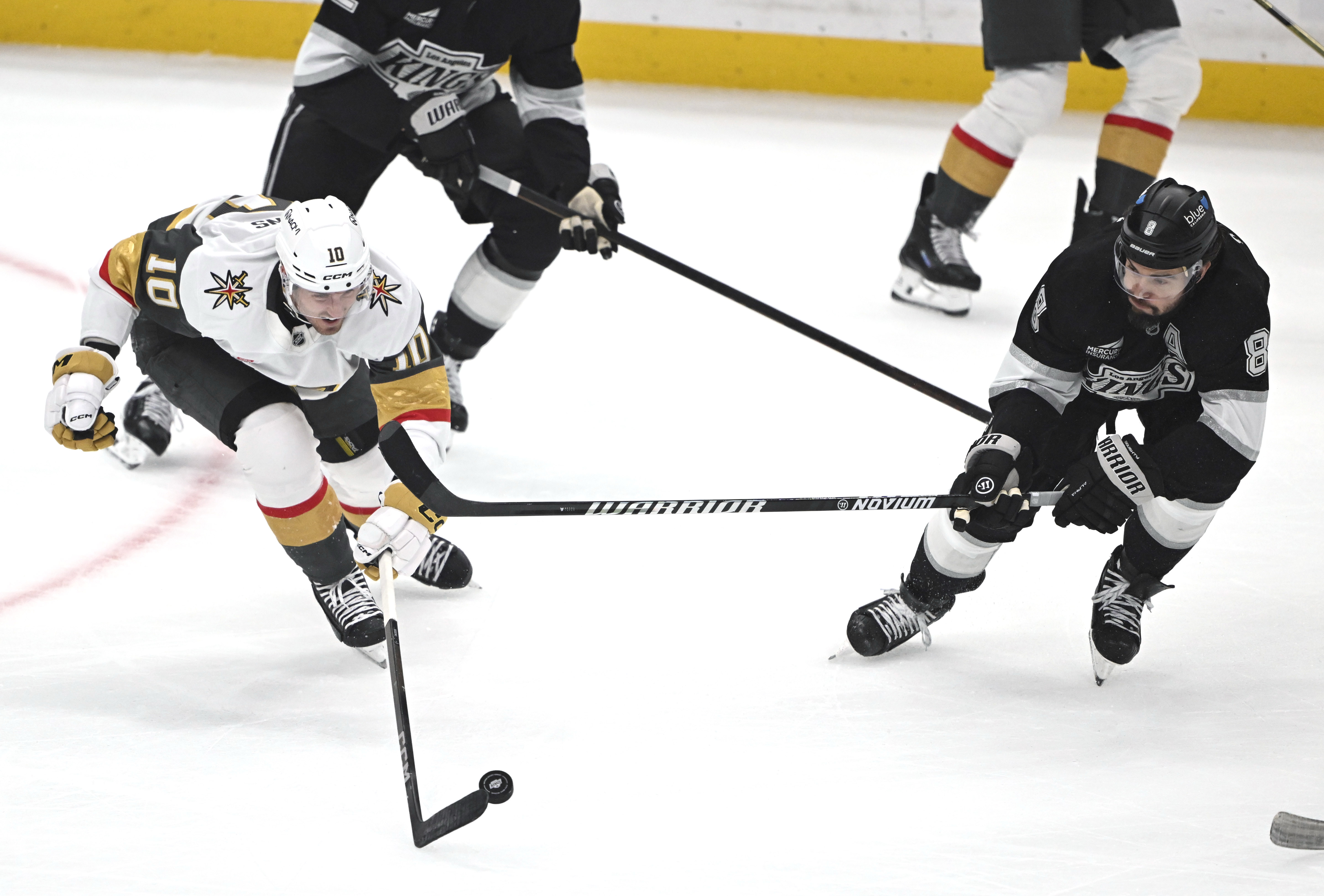 Vegas Golden Knights center Colton Sissons, left, controls the puck...