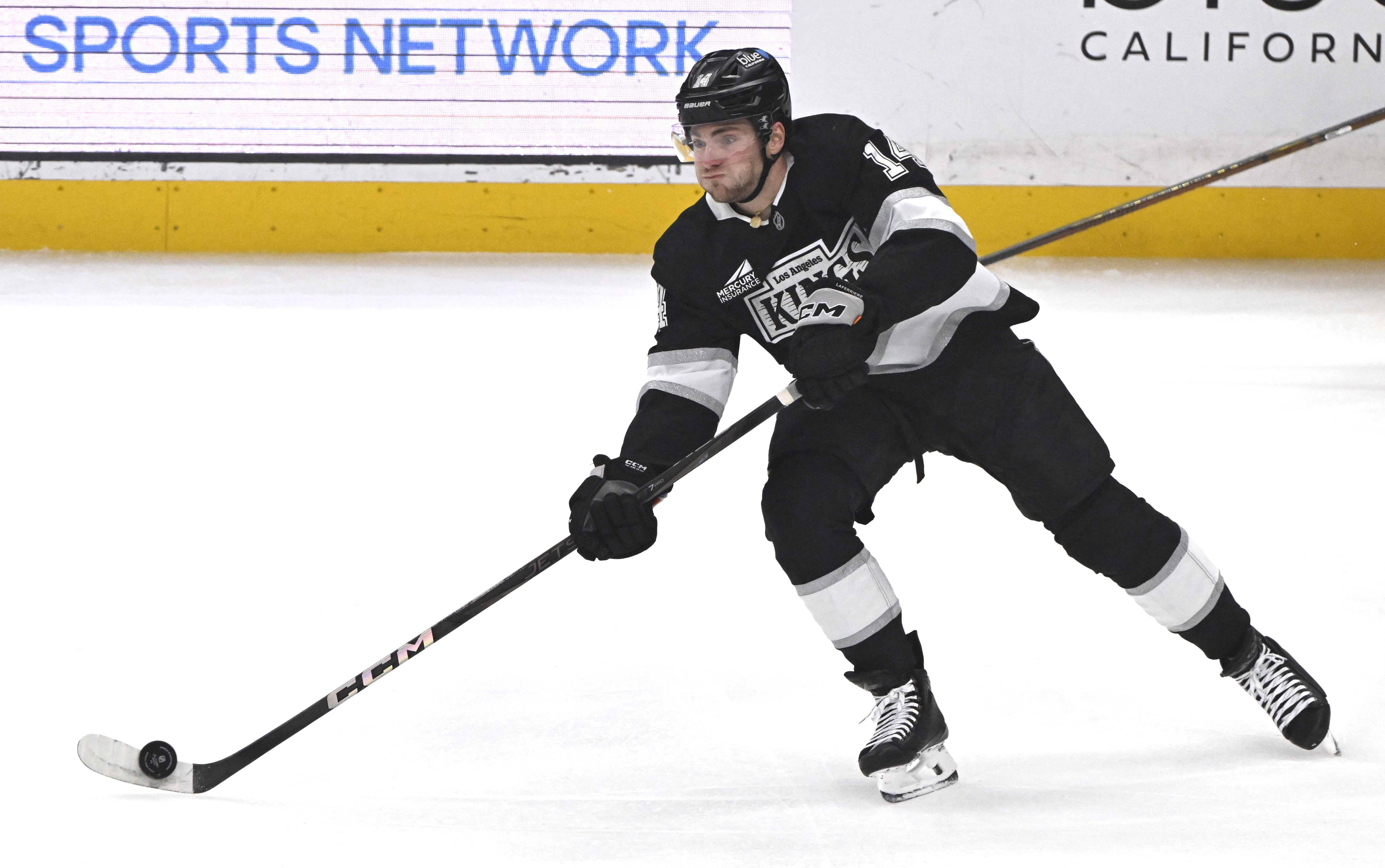 The Kings’ Alex Laferriere controls the puck during the first...