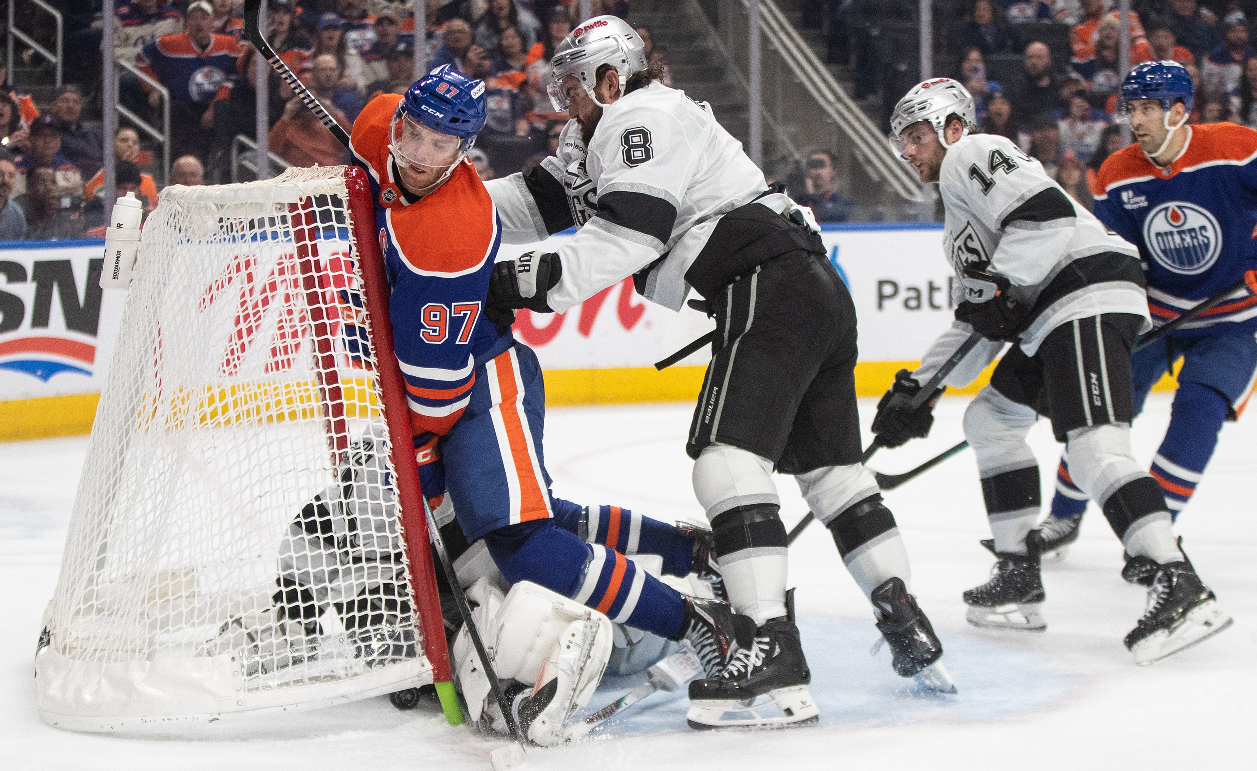 Kings’ Drew Doughty (8) checks Edmonton Oilers’ Connor McDavid (97)...